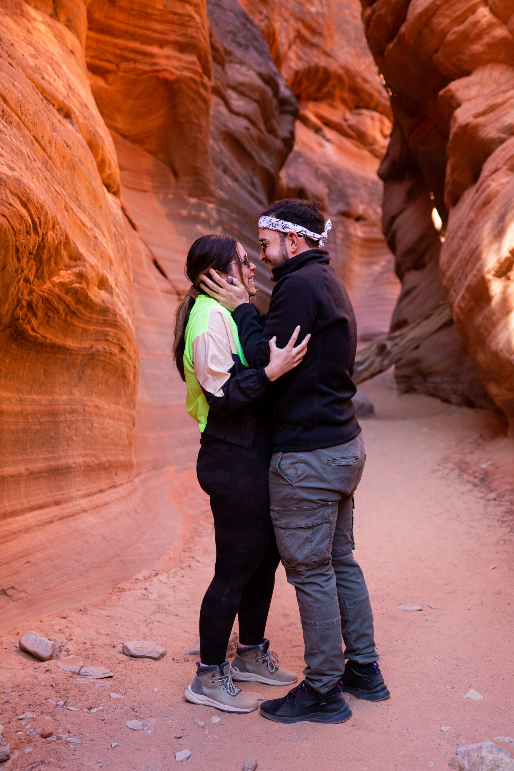 the happy couple holding each other in the canyon in Utah 