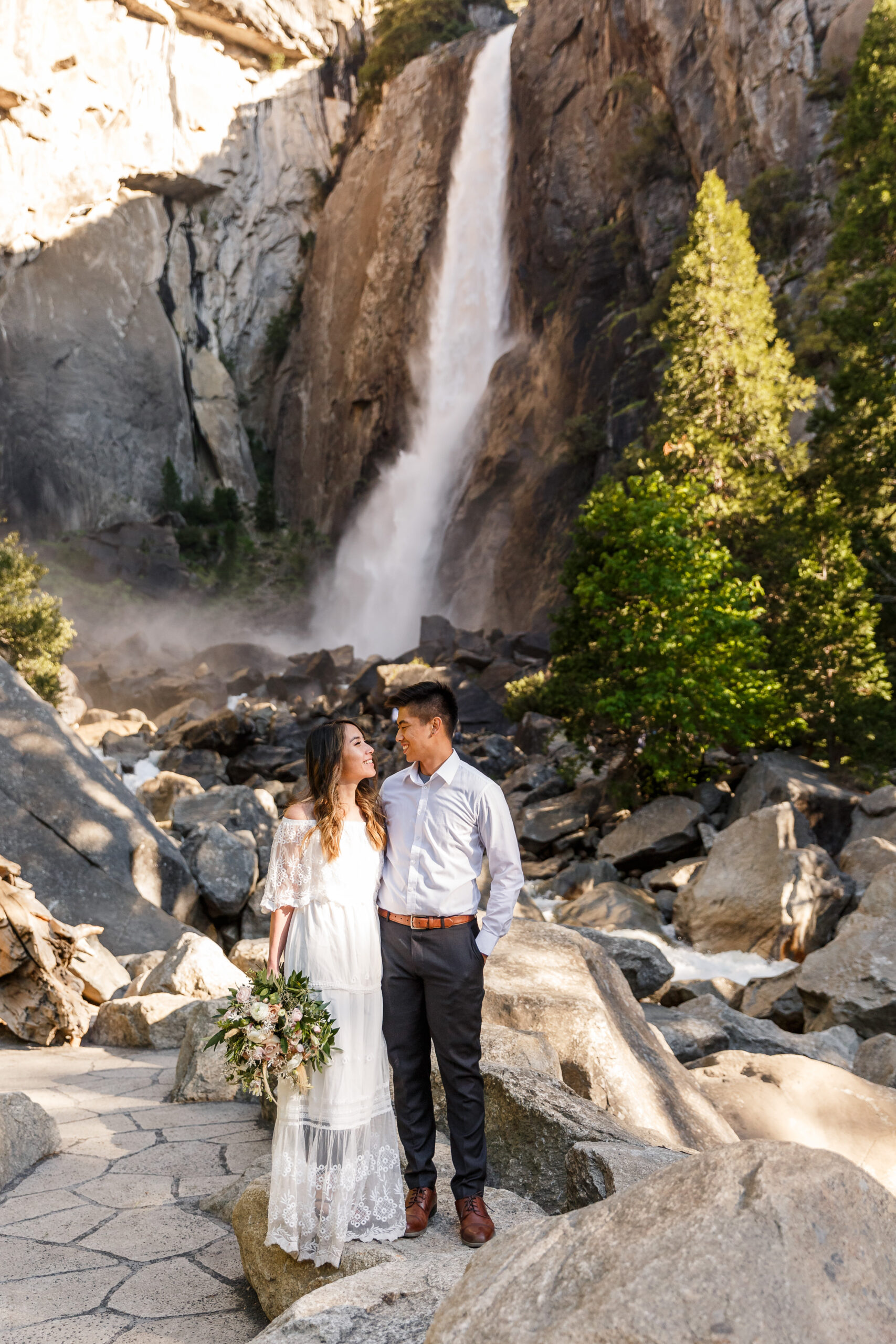 a couple looking at each other by a waterfall during their After Wedding Photoshoot