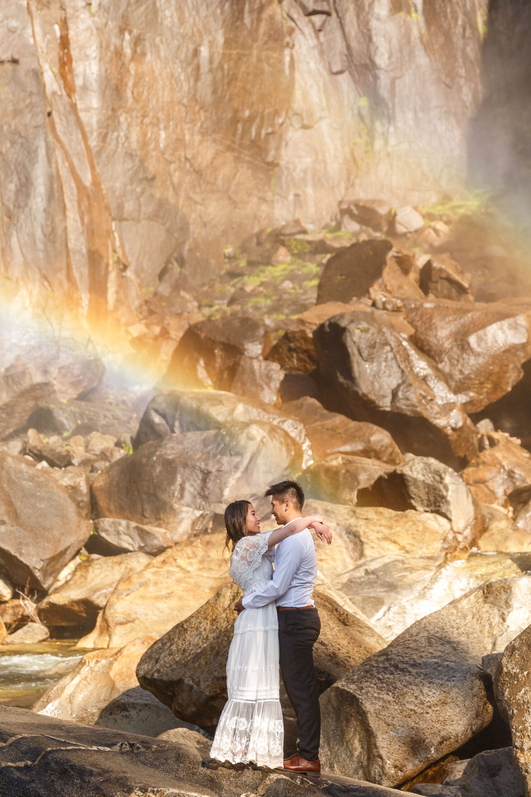 newly married couple standing by a waterfall for their After Wedding Photoshoot