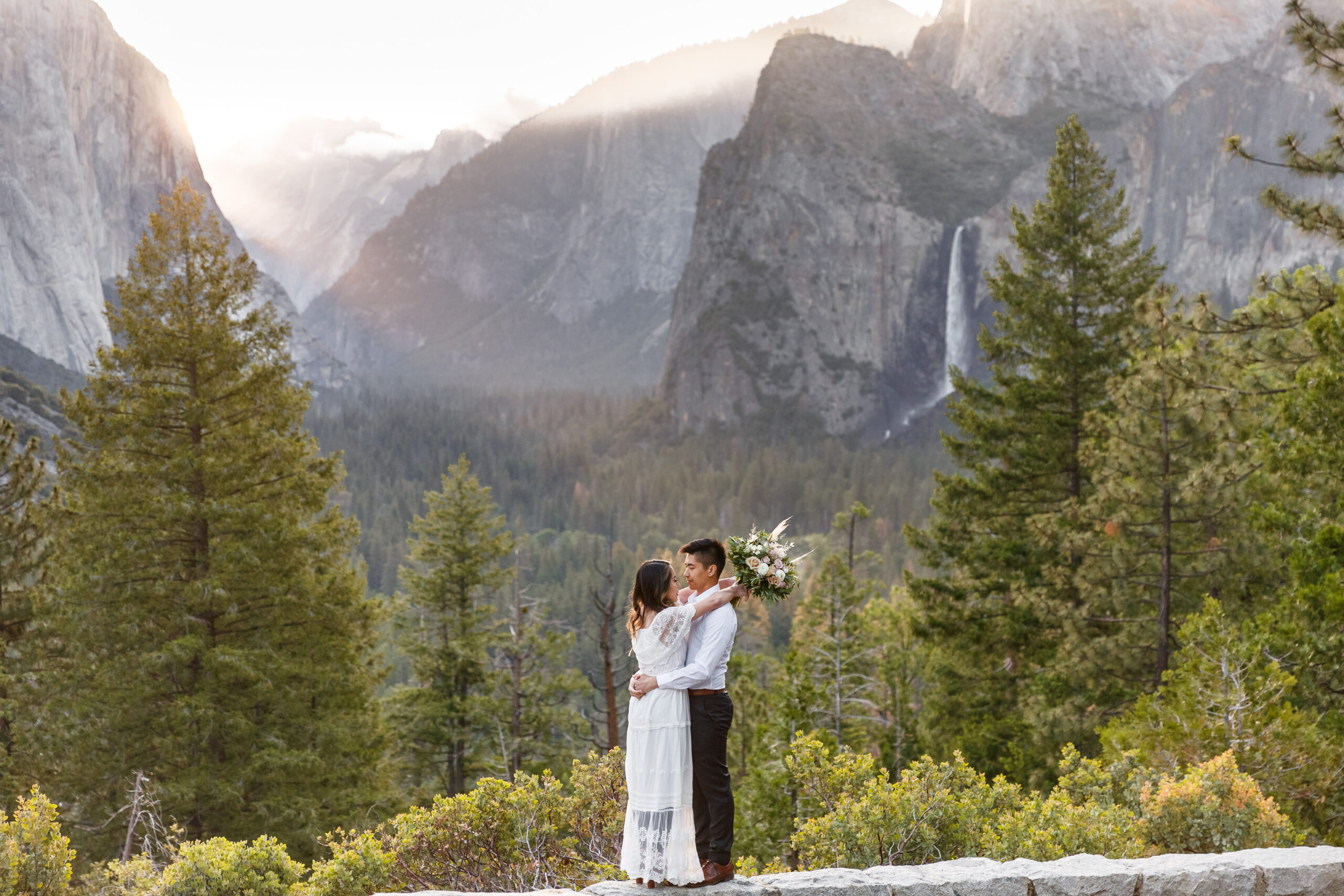 a couple embracing with insane views in Yosemite 