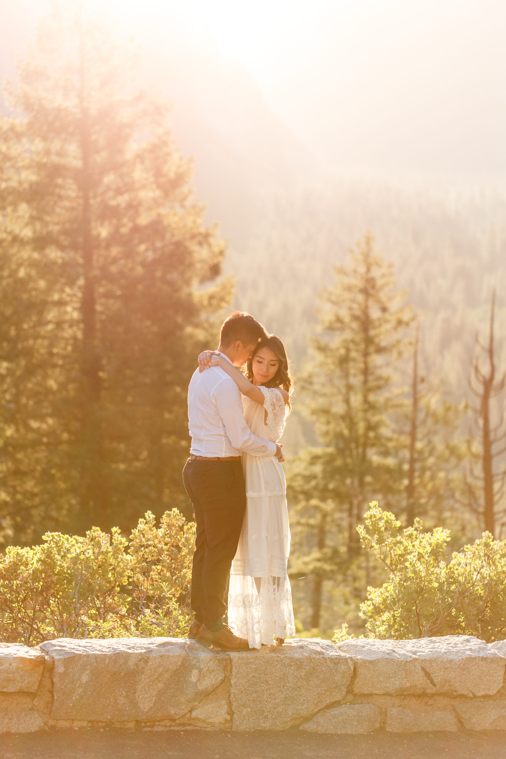 a couple holding each other as the sun shines on them during their After Wedding Photoshoot