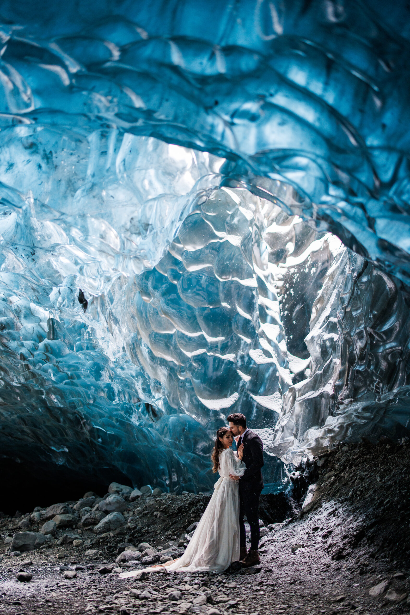 groom kissing bride on top of the head in the ice caves 