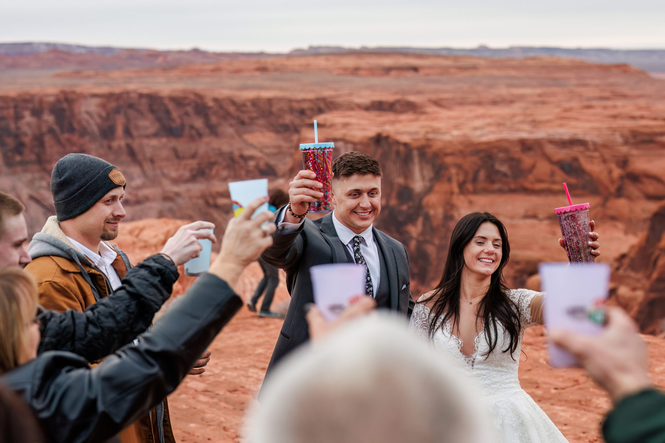 bride and groom and their guests raising a toast together 