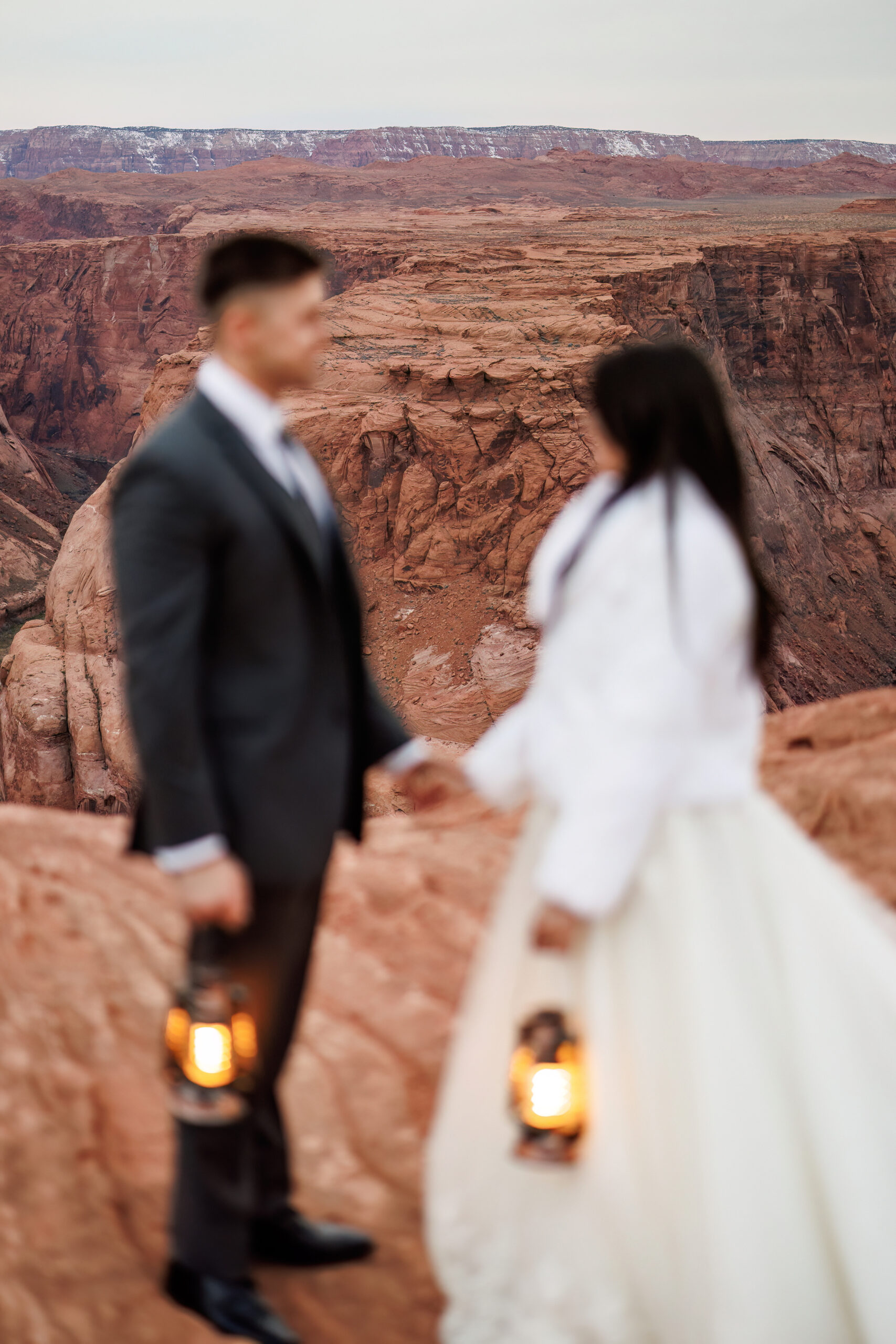 bride and groom blurry with the background of horseshoe bend in focus 