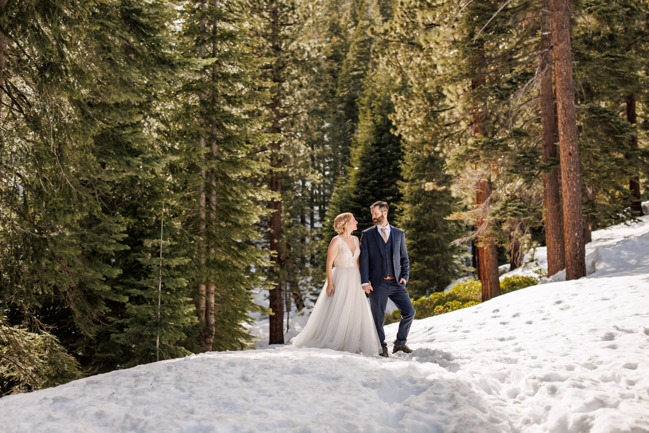 bridal couple walking through the snow in lake Tahoe 