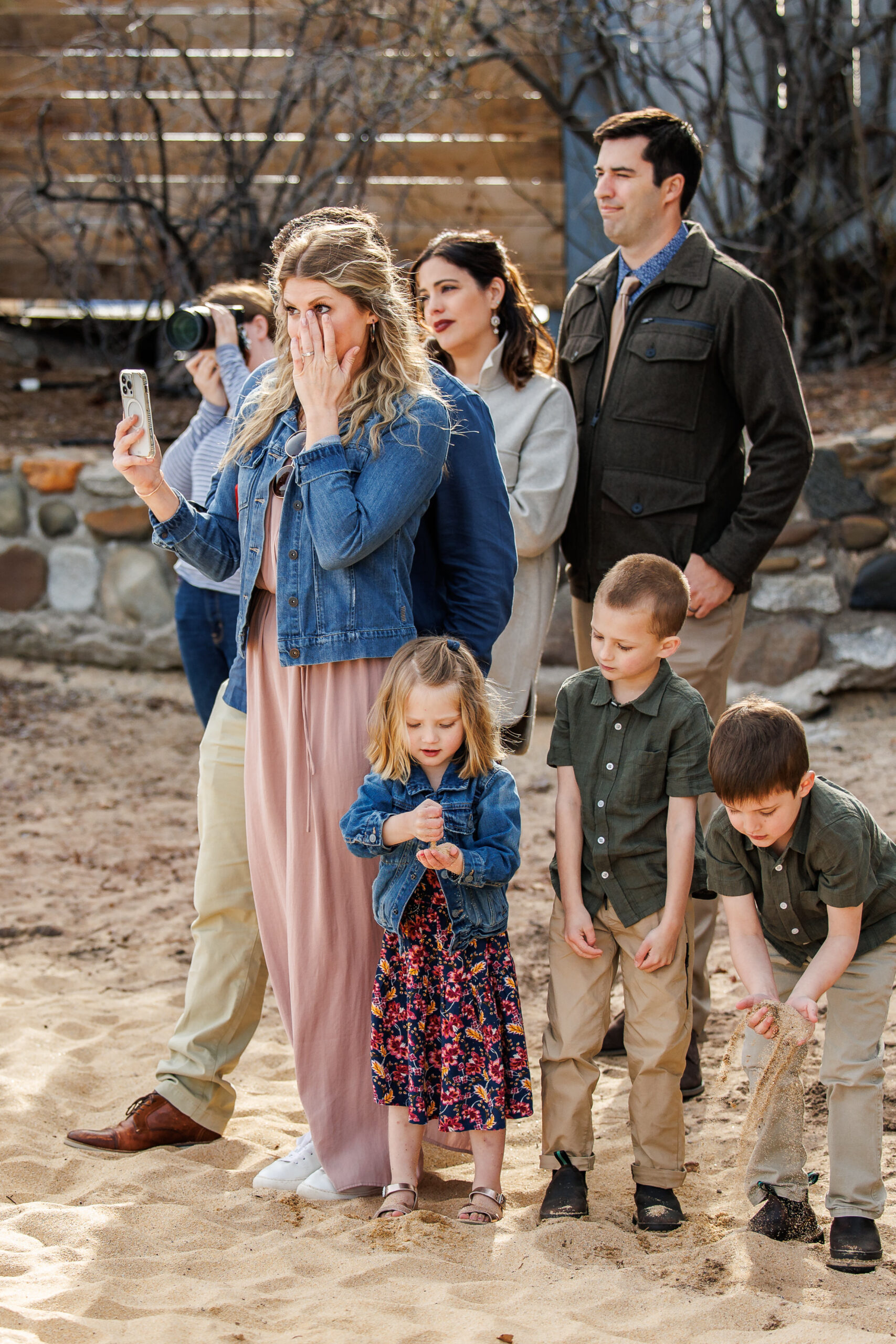 winter elopement guests watching the intimate beach ceremony 