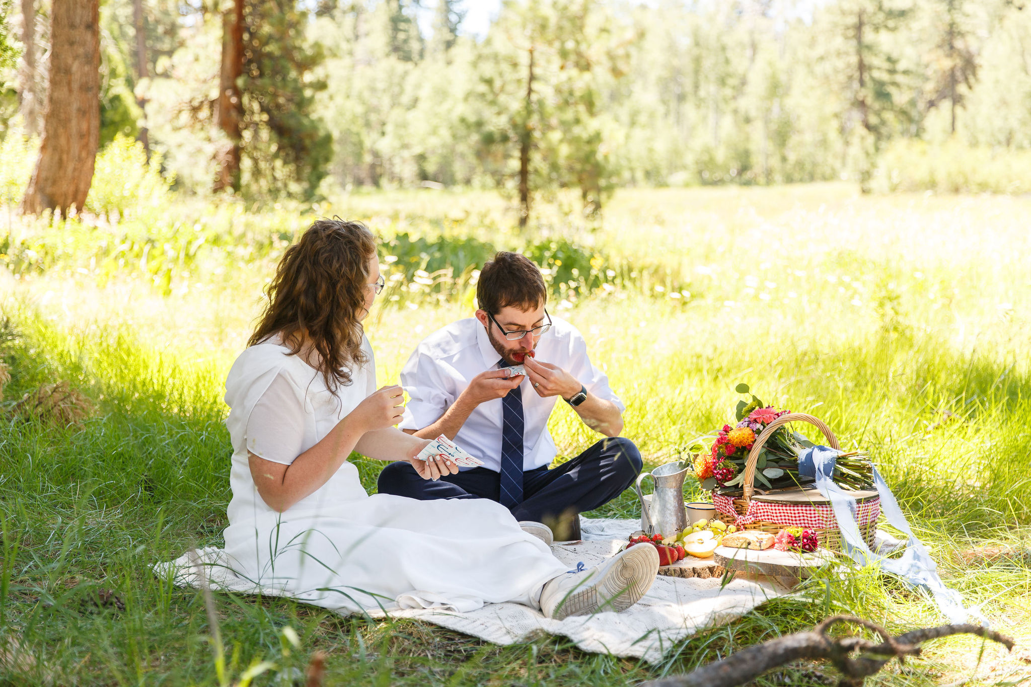 newly weds enjoying a picnic together after their ceremony