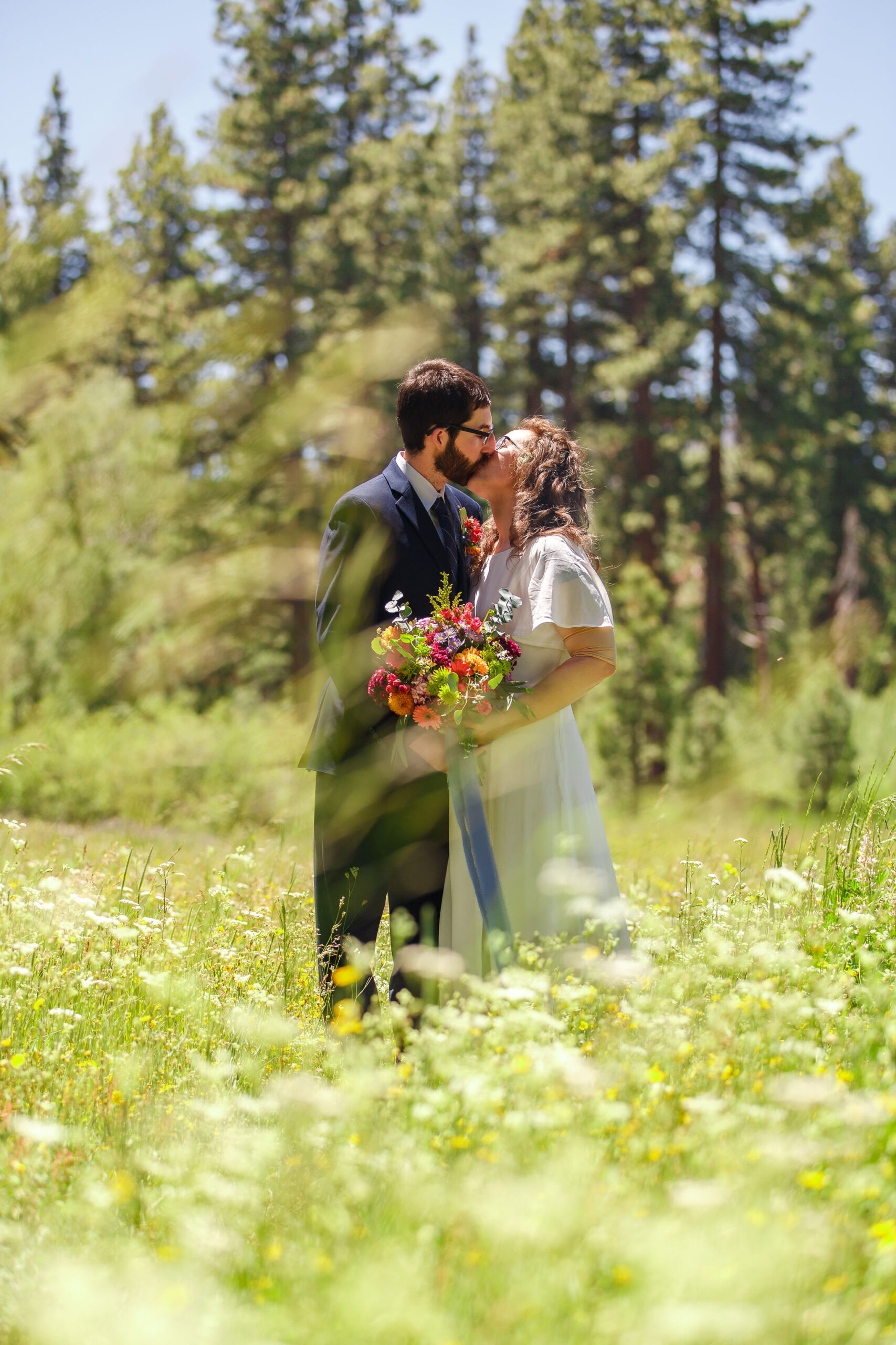 newly weds kissing in a wildflower meadow in Lake Tahoe on their elopement day 