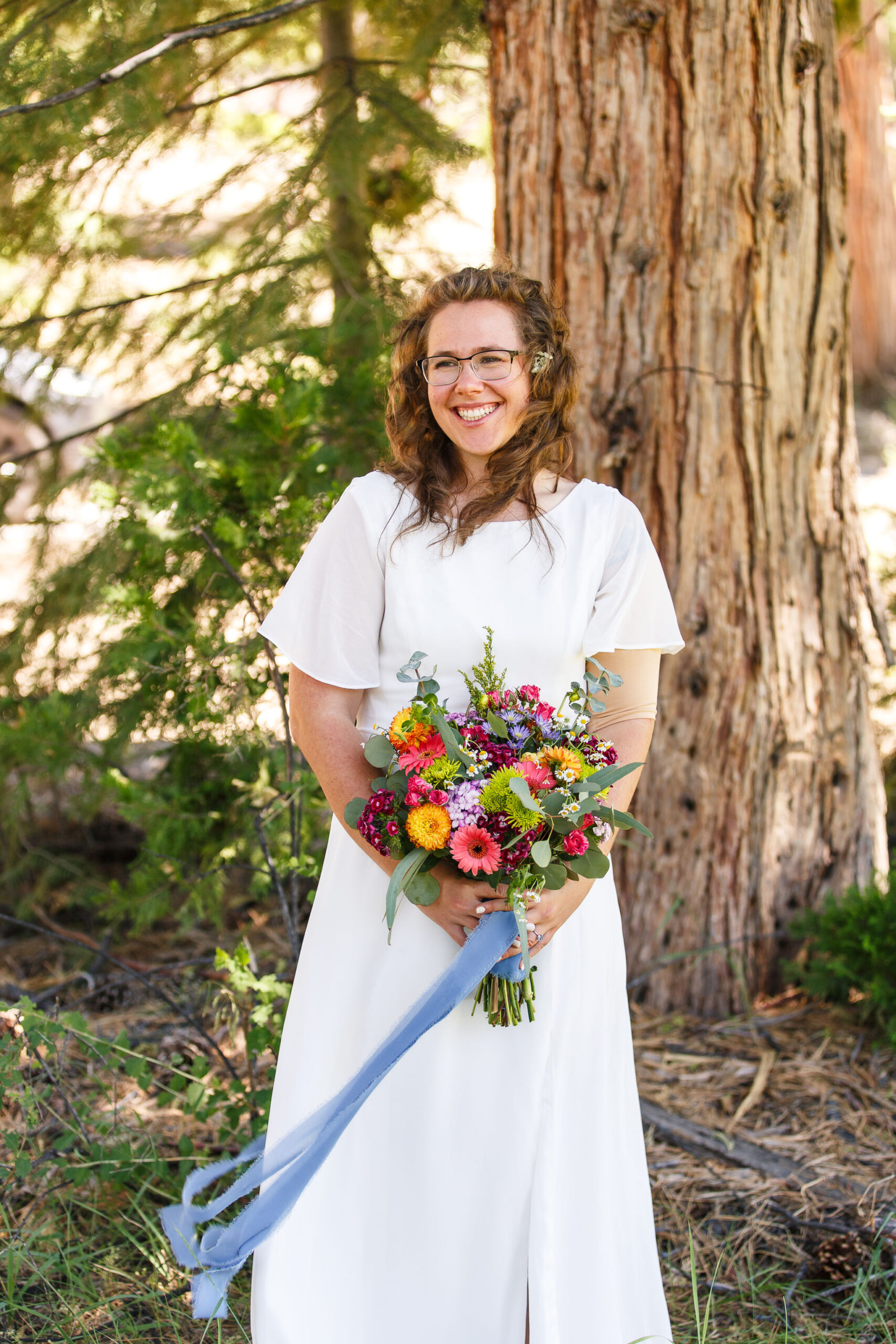 bridal portrait in a flower meadow holding a wildflower bouquet 