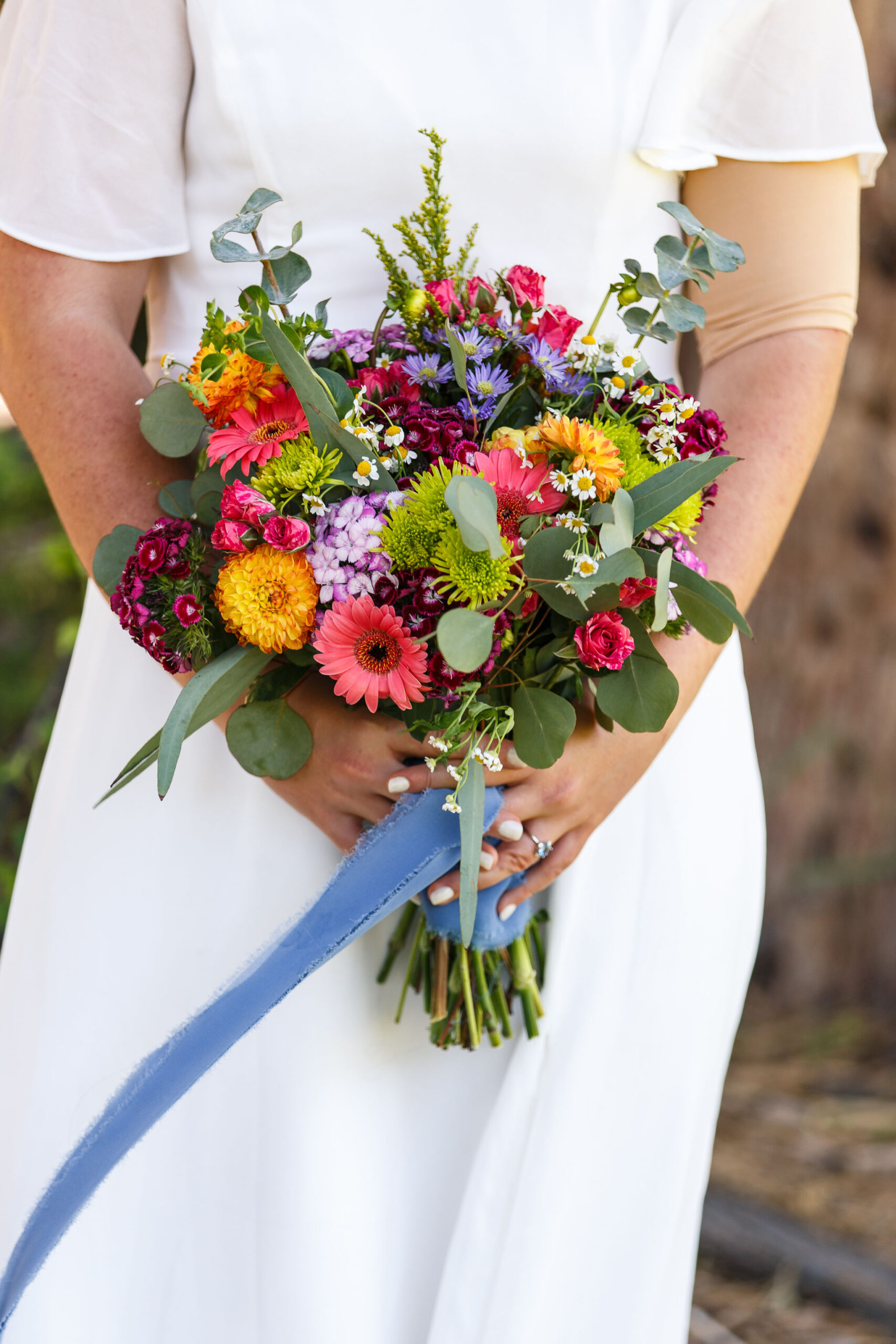 bride holding her wildflower bouquet 