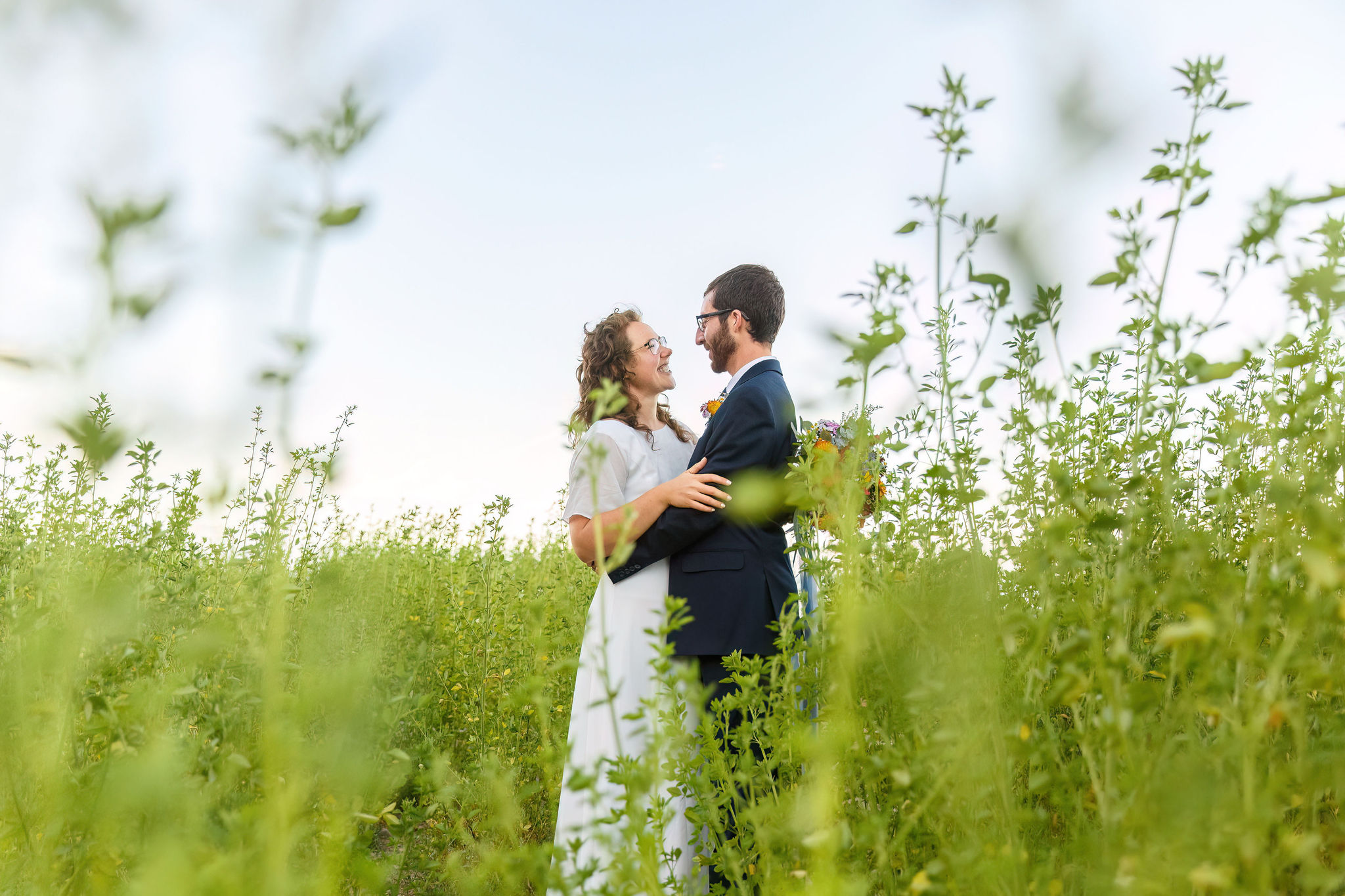 bride and groom holding each other and smiling after their elopement 