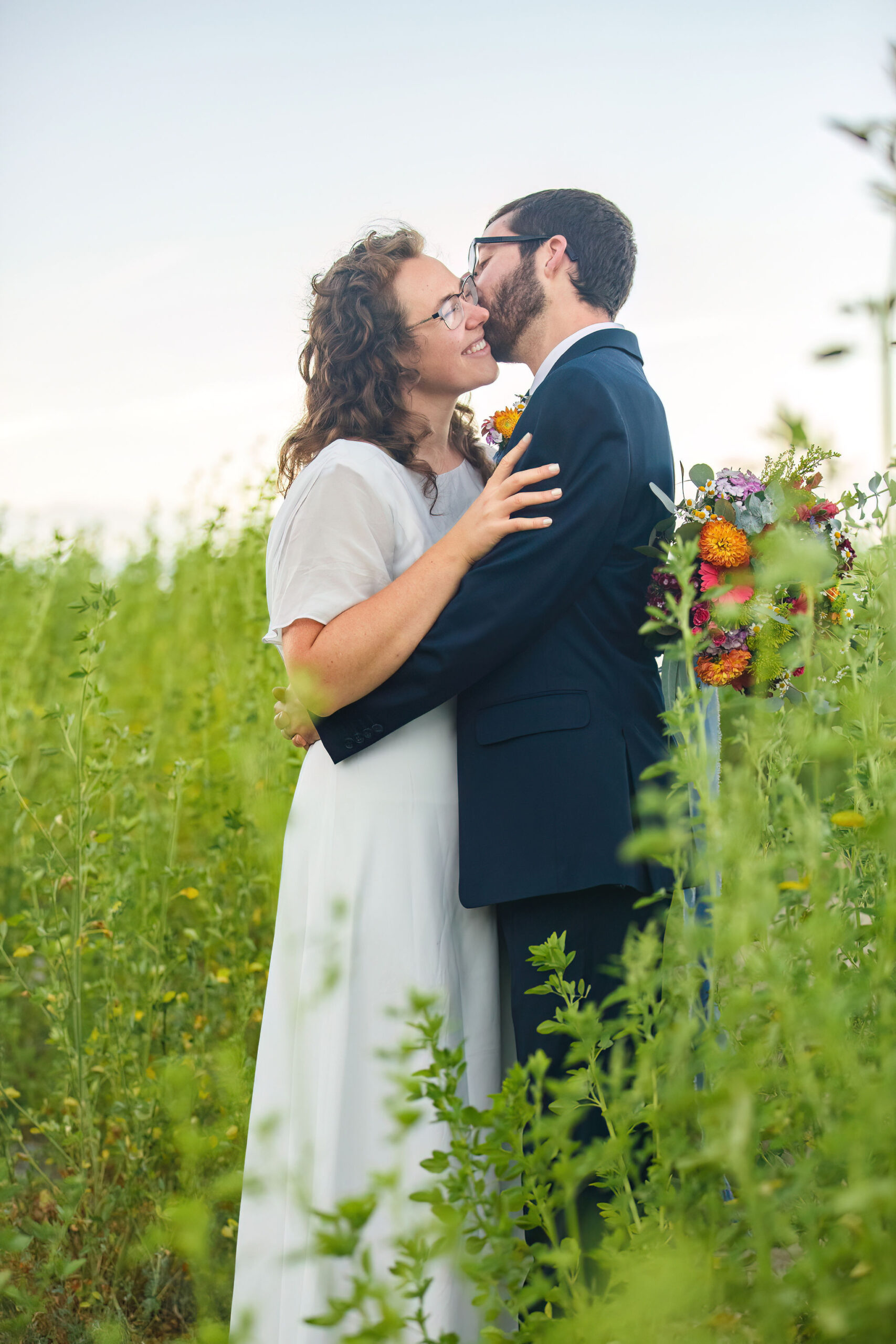 newly weds in a wildflower meadow about to have a picnic and enjoy some Elopement Activities