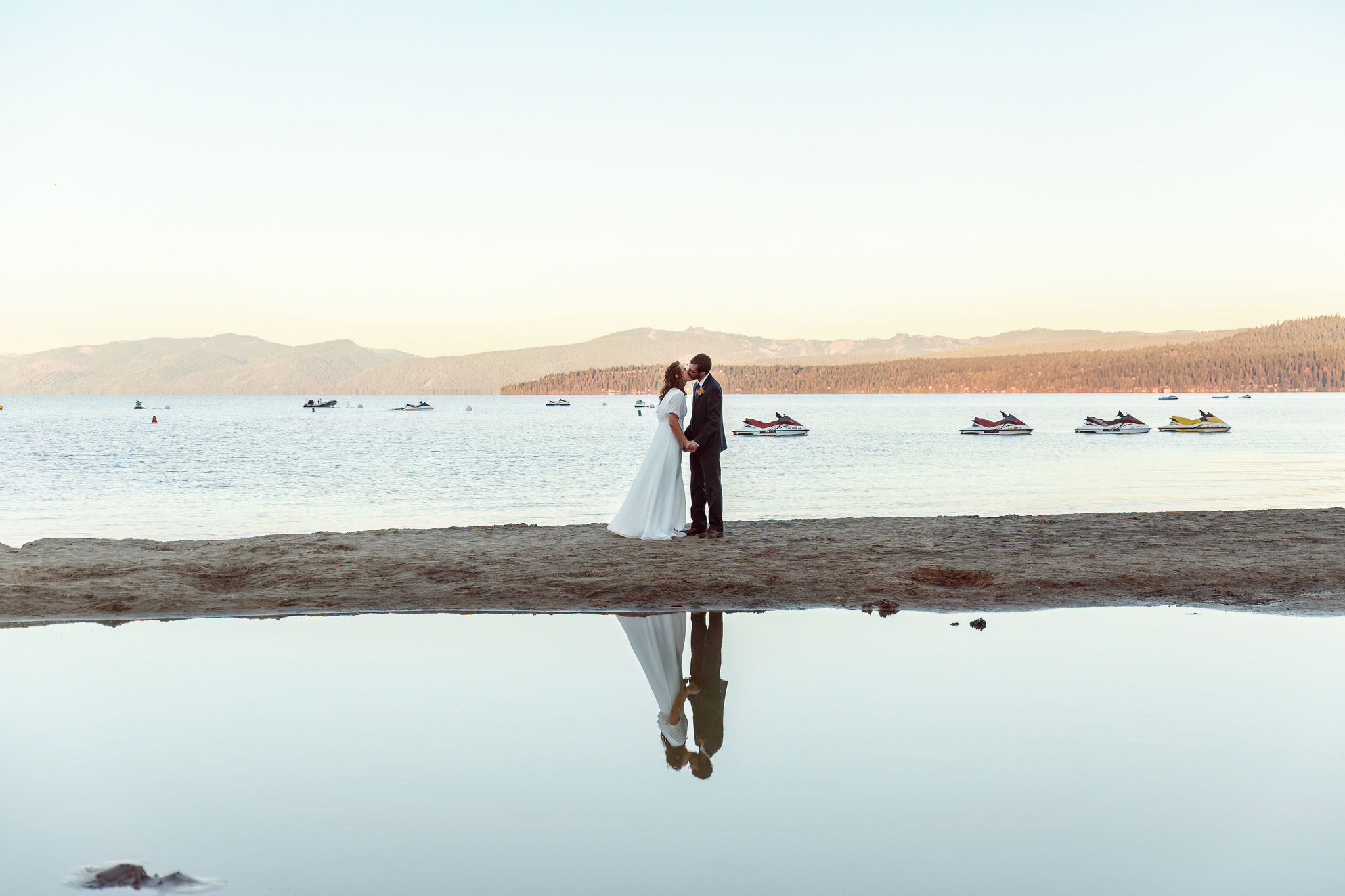 bride and groom kissing with lake Tahoe as their backdrop, a sunrise first look is a great Elopement Activity idea