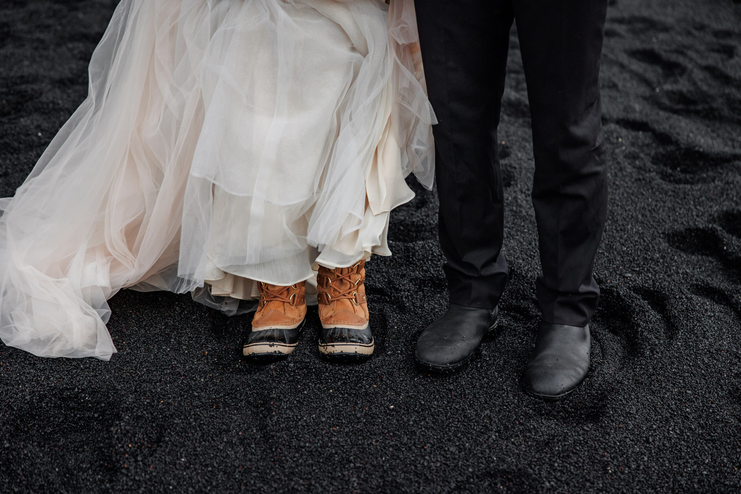 bride and groom's warm shoes in the black sand beaches of Iceland 