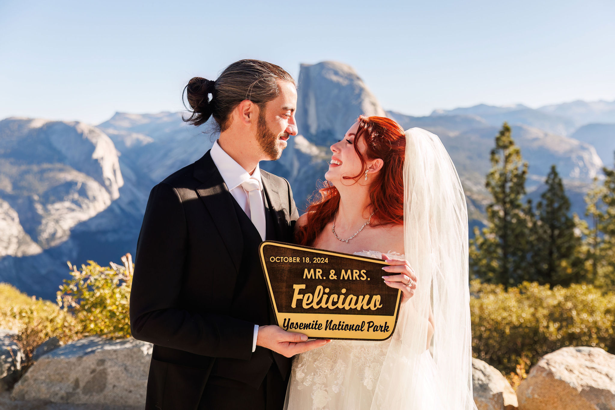 bride and groom holding up their national park wedding sign