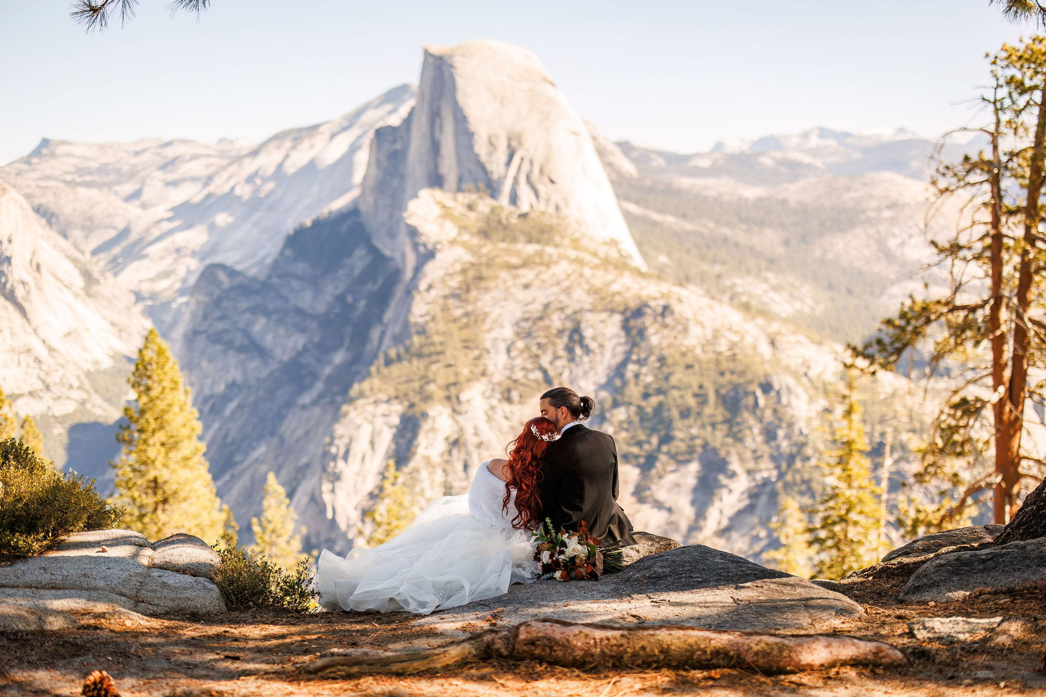 bride and groom sitting together enjoying the view for Yosemite elopement photos 