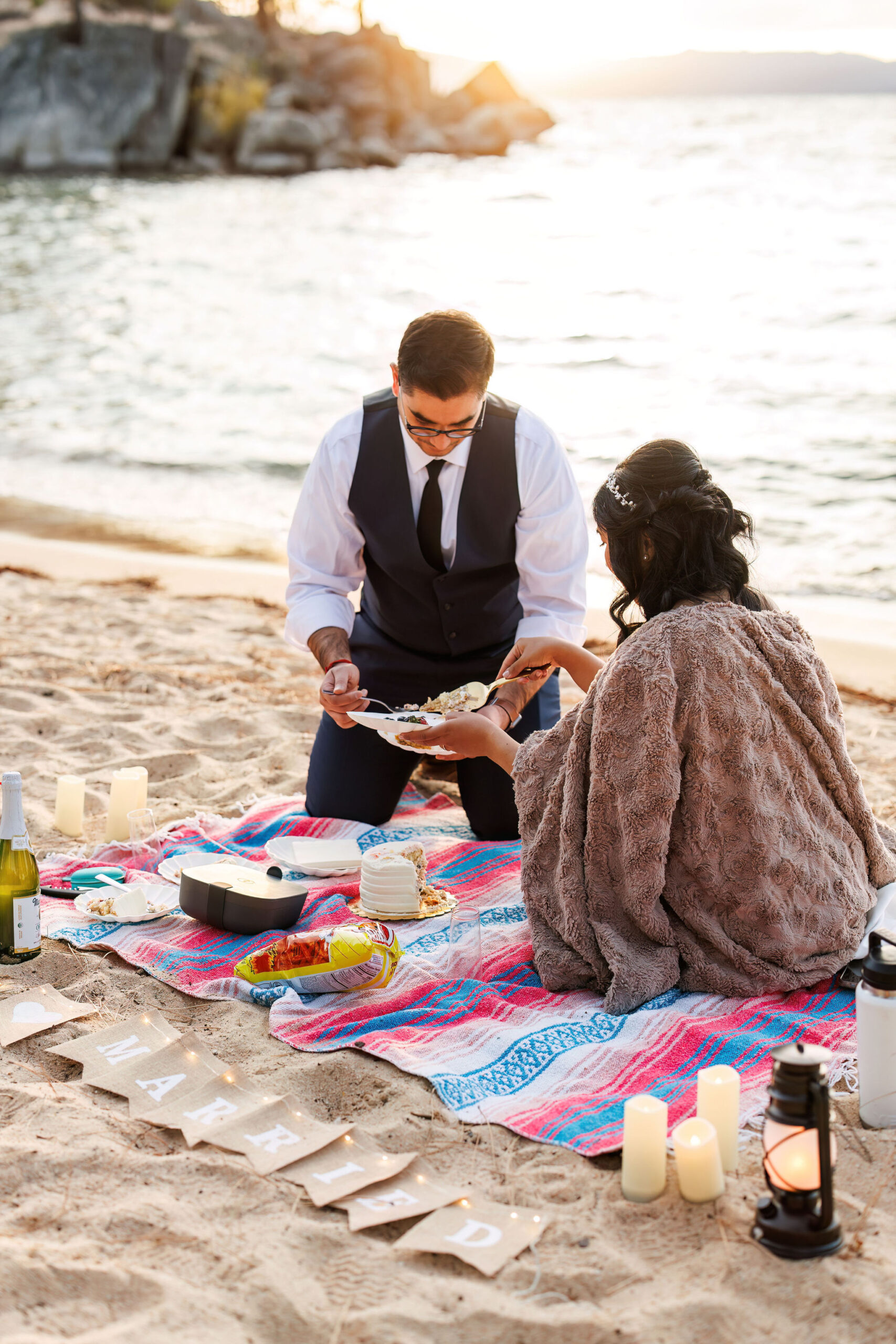 bride and groom having a beach picnic for their Elopement in Lake Tahoe