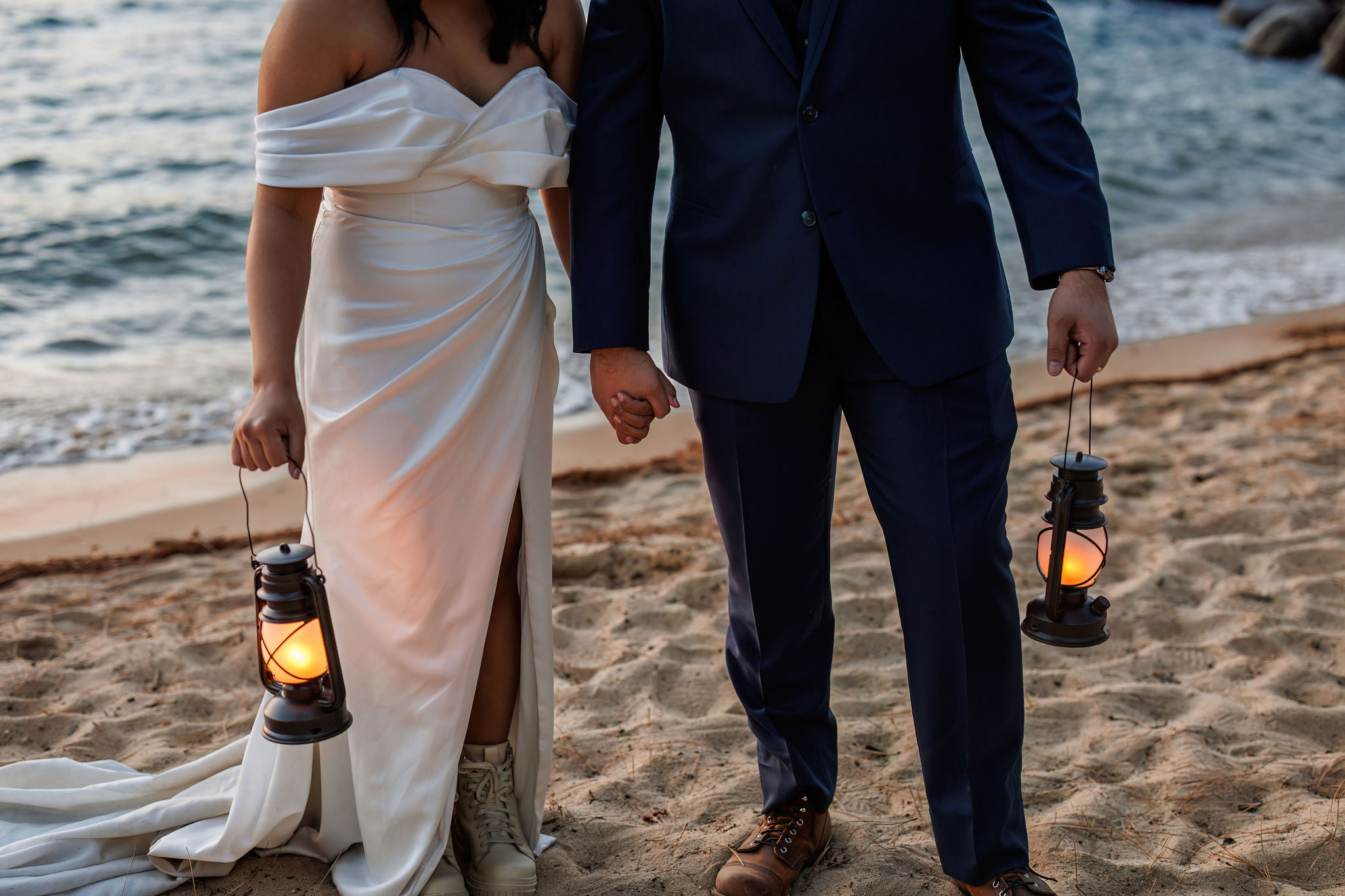 bride and groom holding lanterns during blue hour 