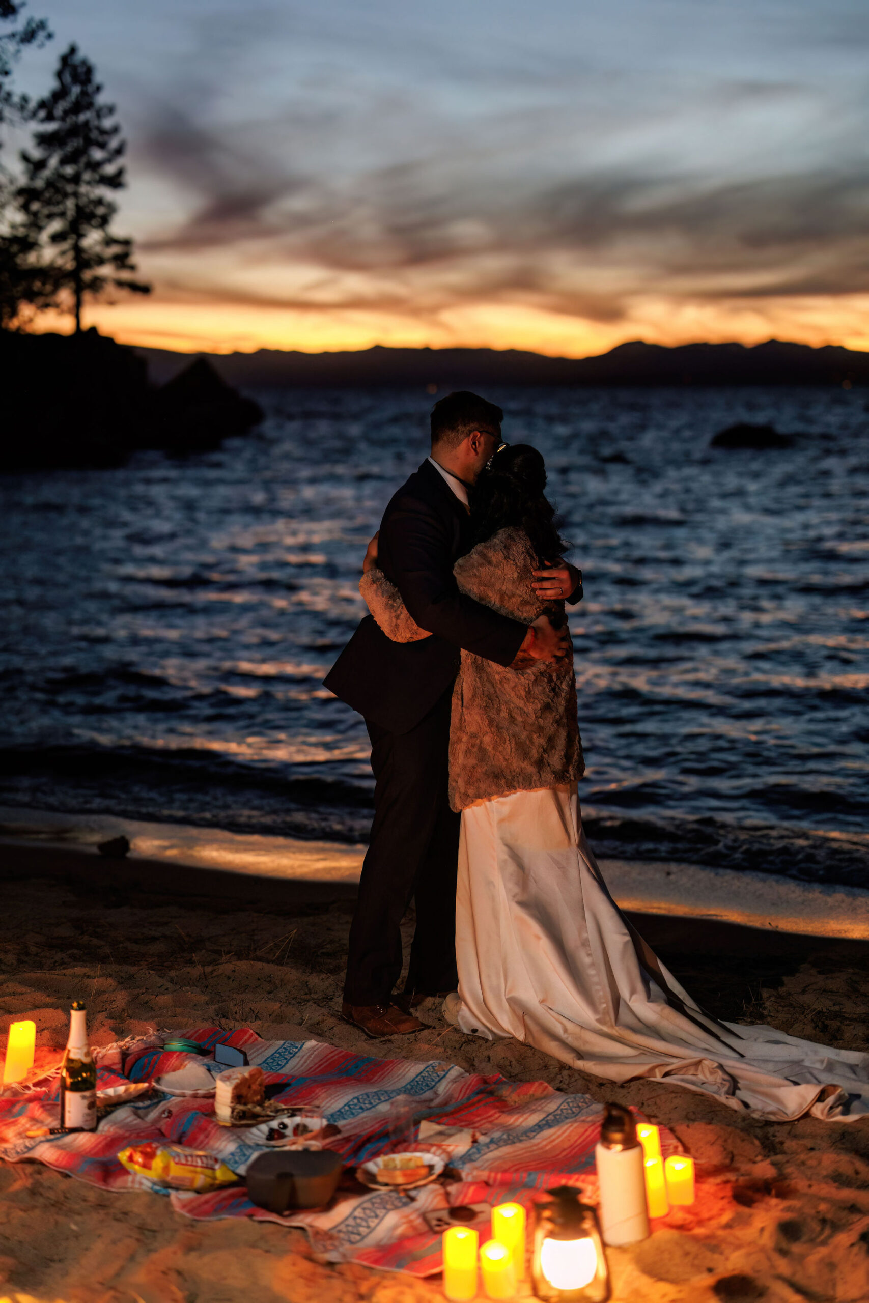 bridal couple dancing as the sun goes down on the beach 