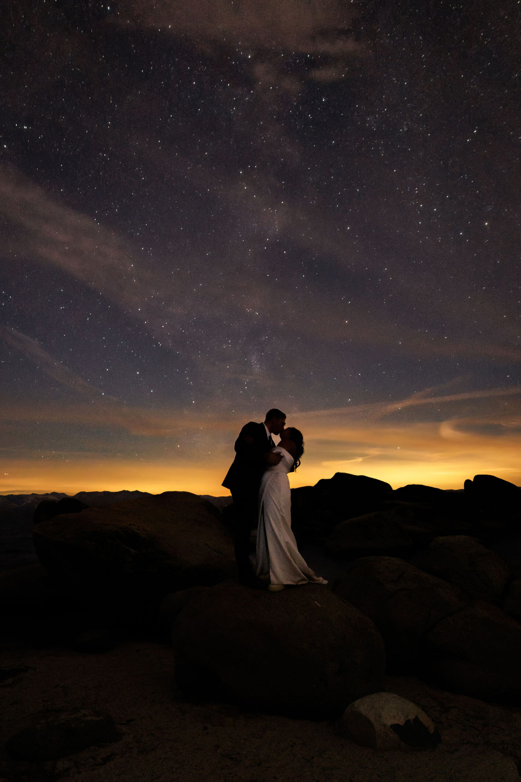 bride and groom portraits at night with the galaxy above them 