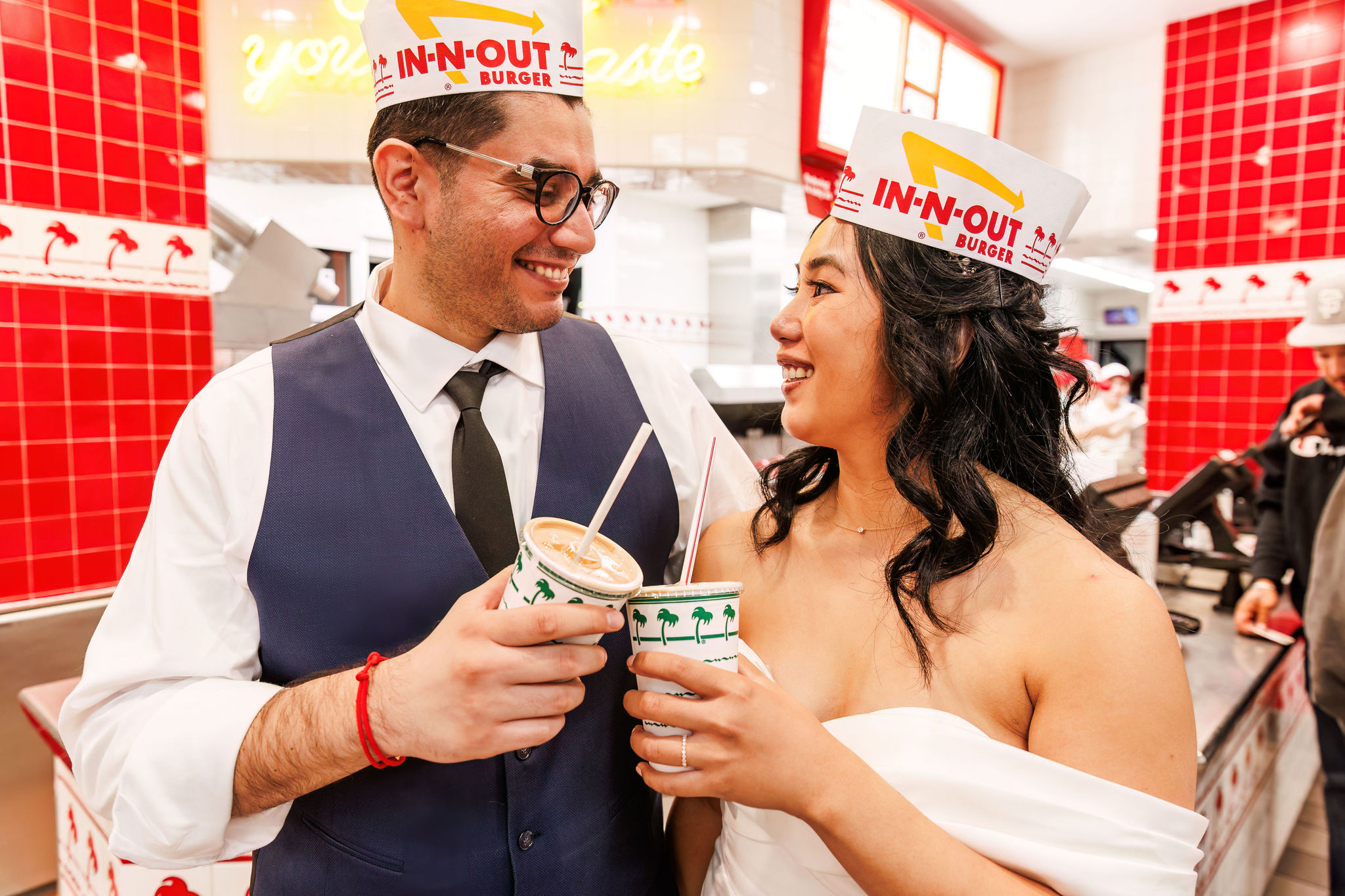 bride and groom with in-n-out hats on 