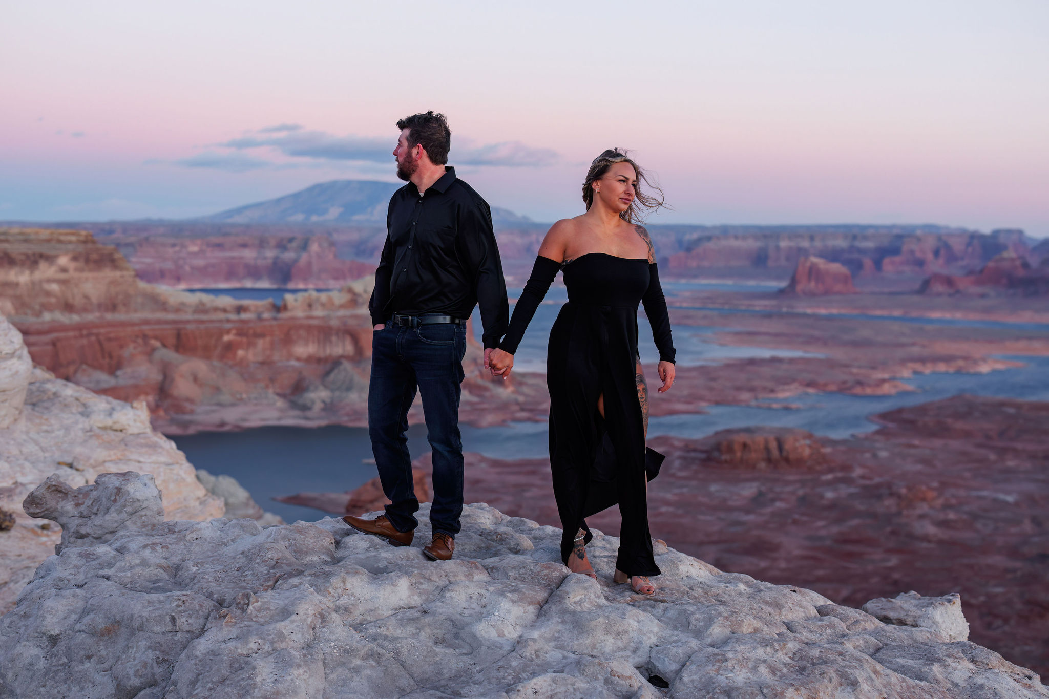 a couple standing apart during their sunset engagement photos 