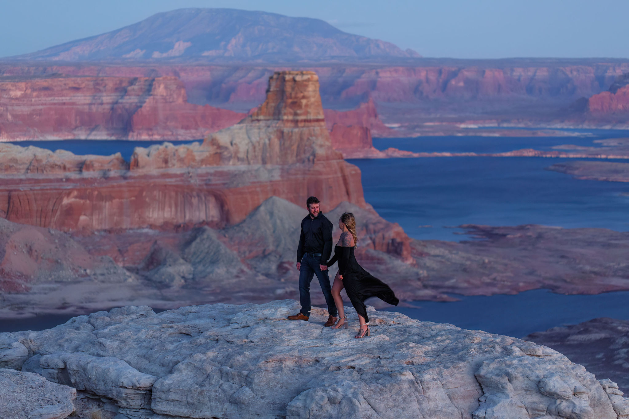 a couple walking along a rock ledge during their documentary engagement photos 