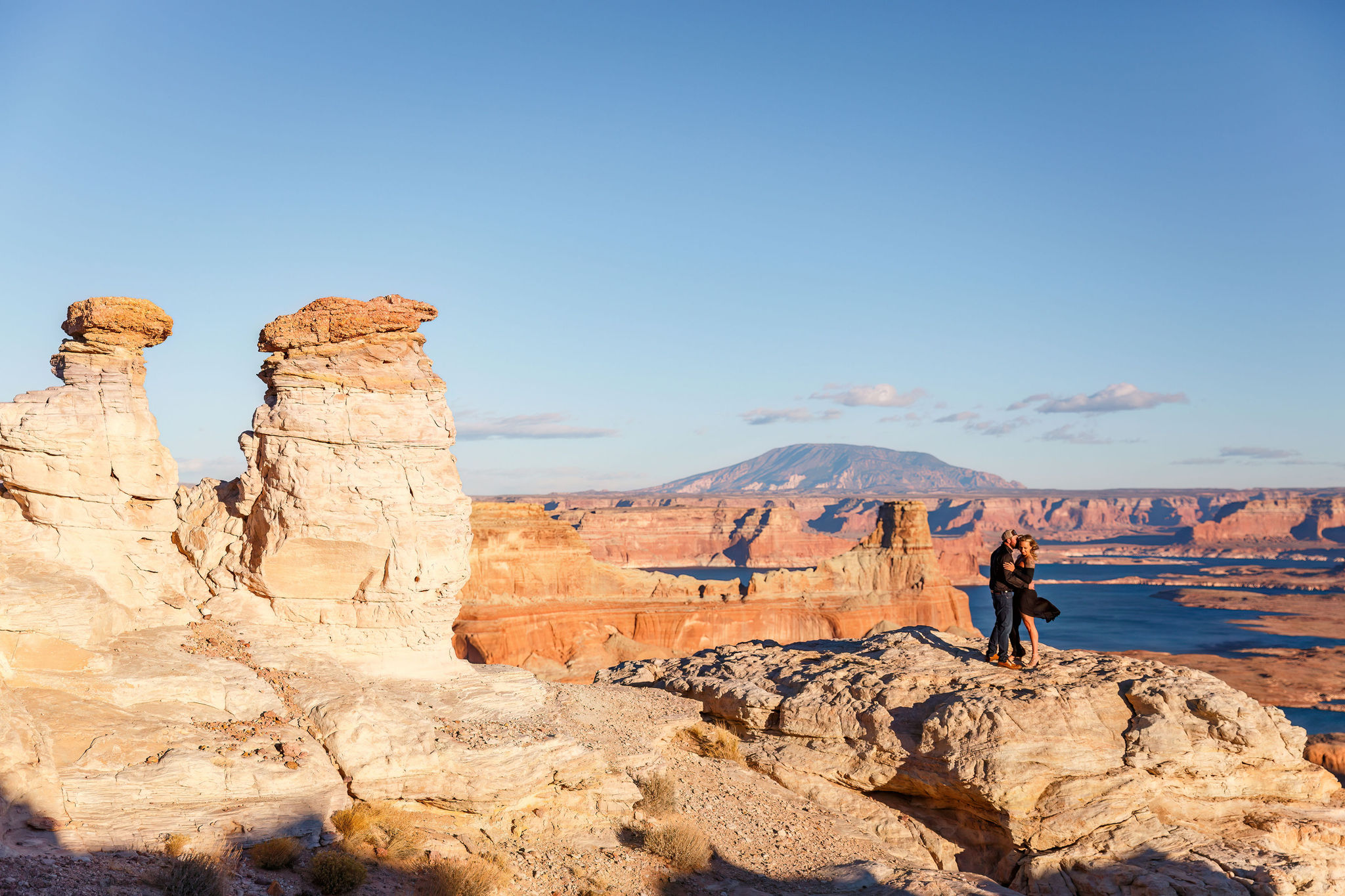 a couple holding each other while standing on Alstrom Point 