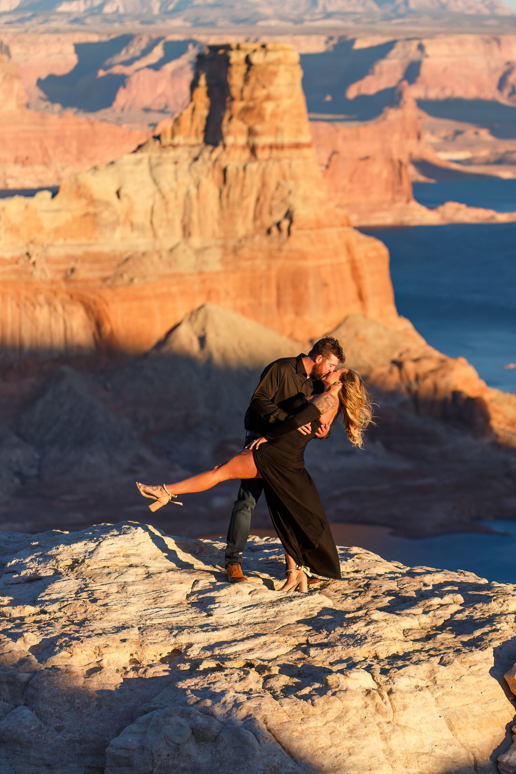 a man dipping a woman at Lake Powell during their Utah engagement photos