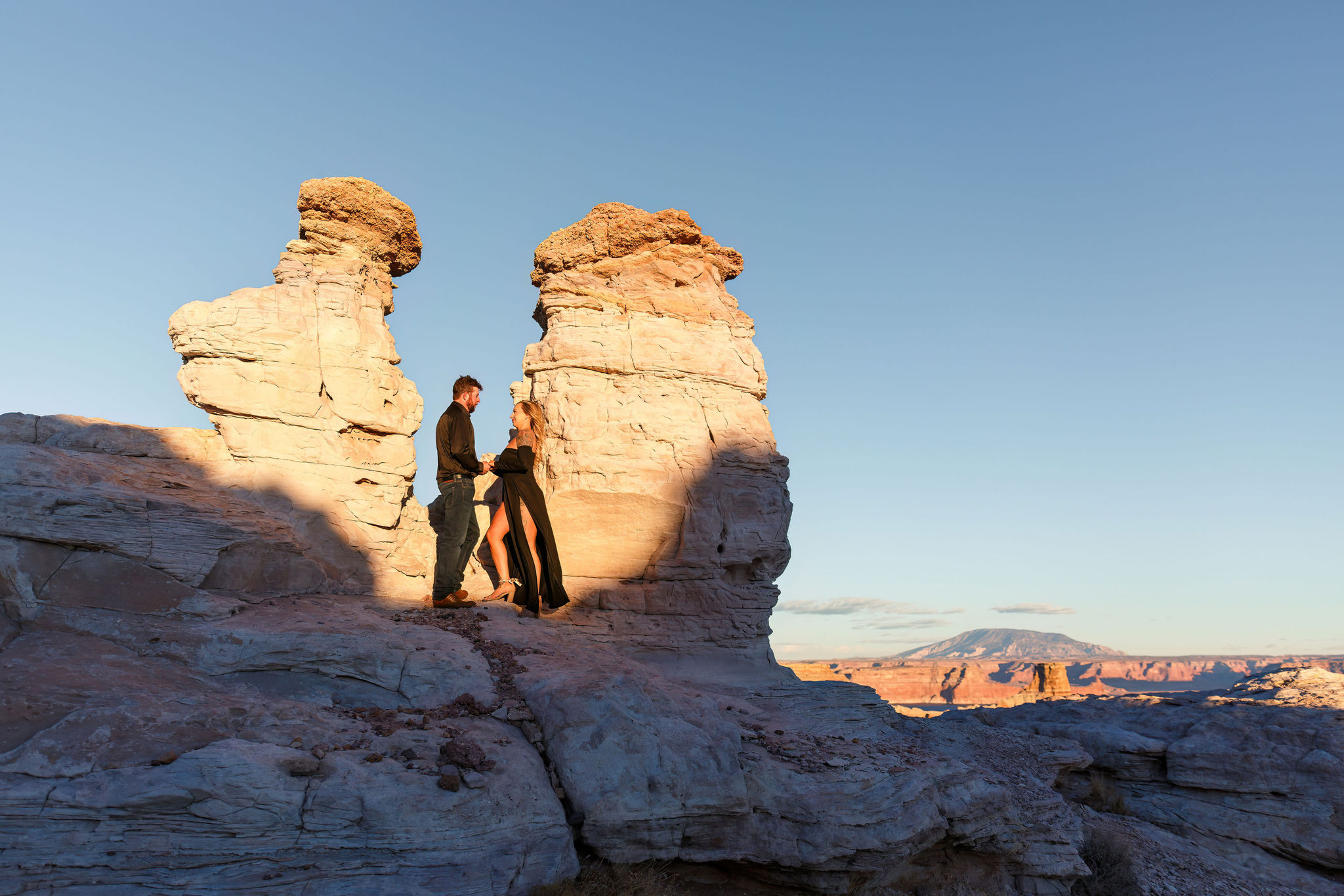 newly engaged couple standing by a cool rock formation at Alstrom Point 