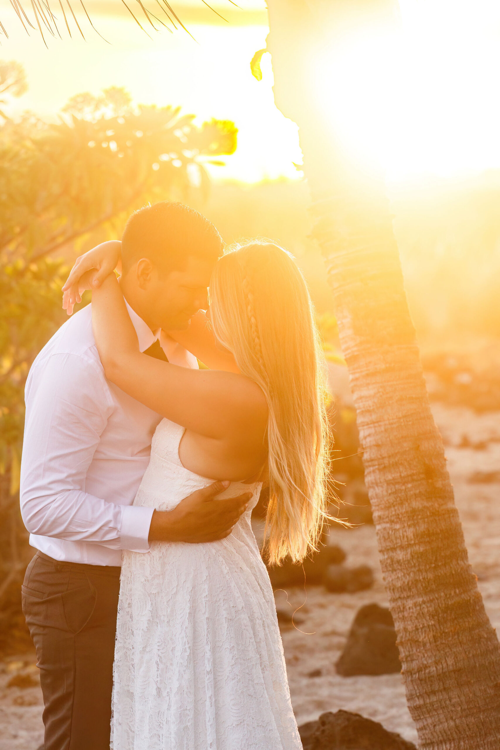 a couple holding each other on the beach during sunset for their Hawaii elopement 