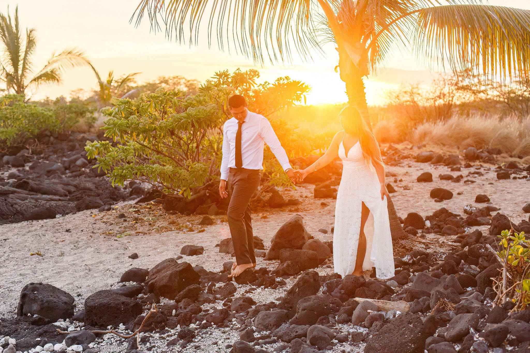 a couple walking together on the beach during sunset for their Hawaii elopement 