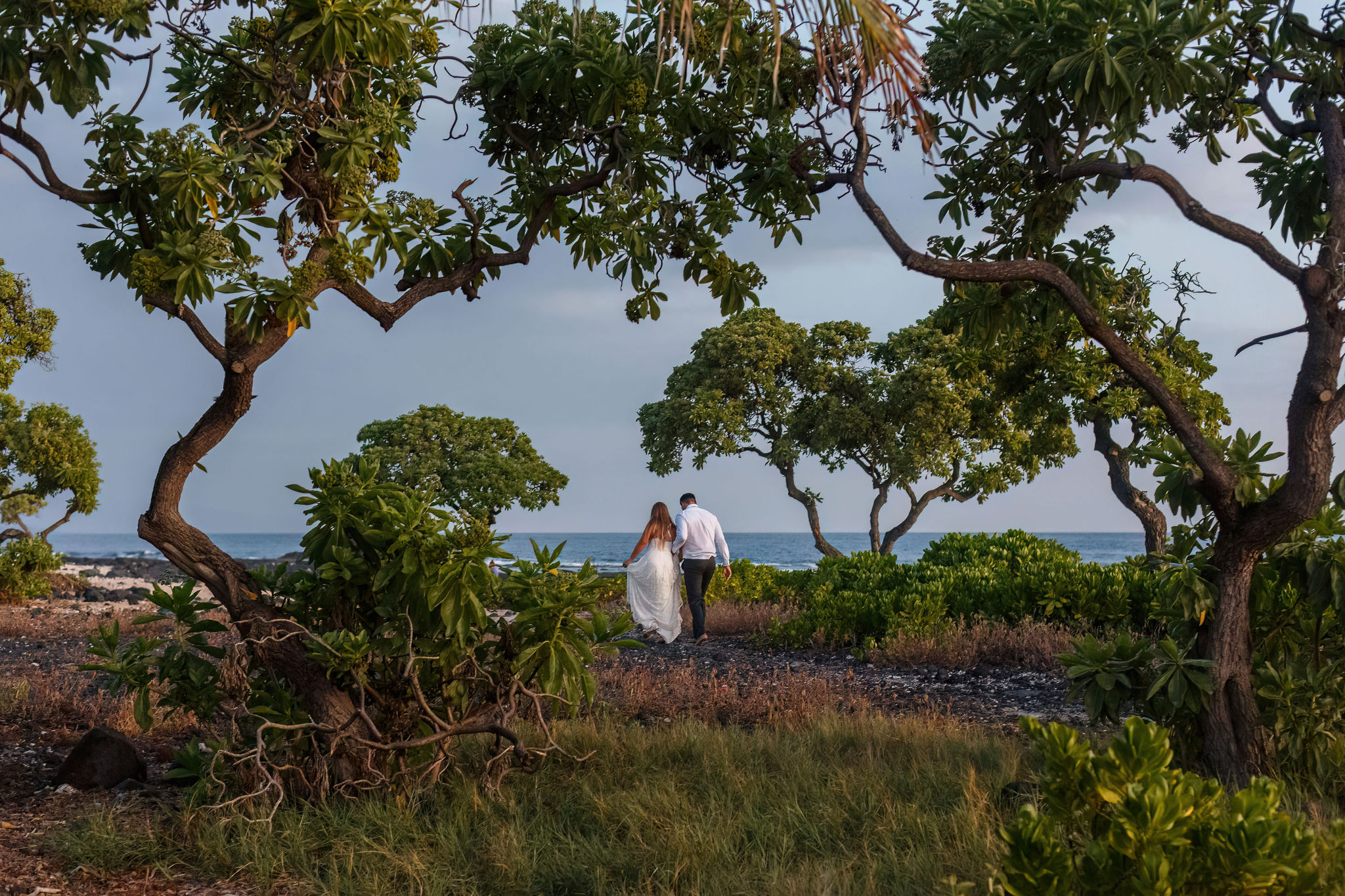 a couple walking towards the beach for their Hawaii elopement 