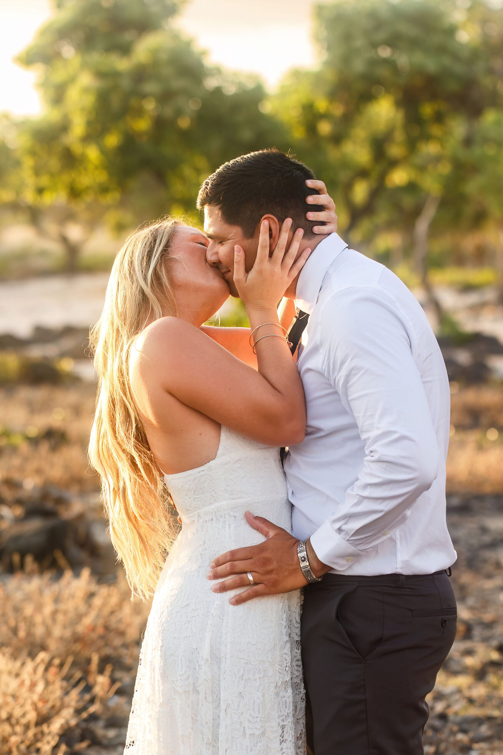 newly weds kissing on the beach in Hawaii 