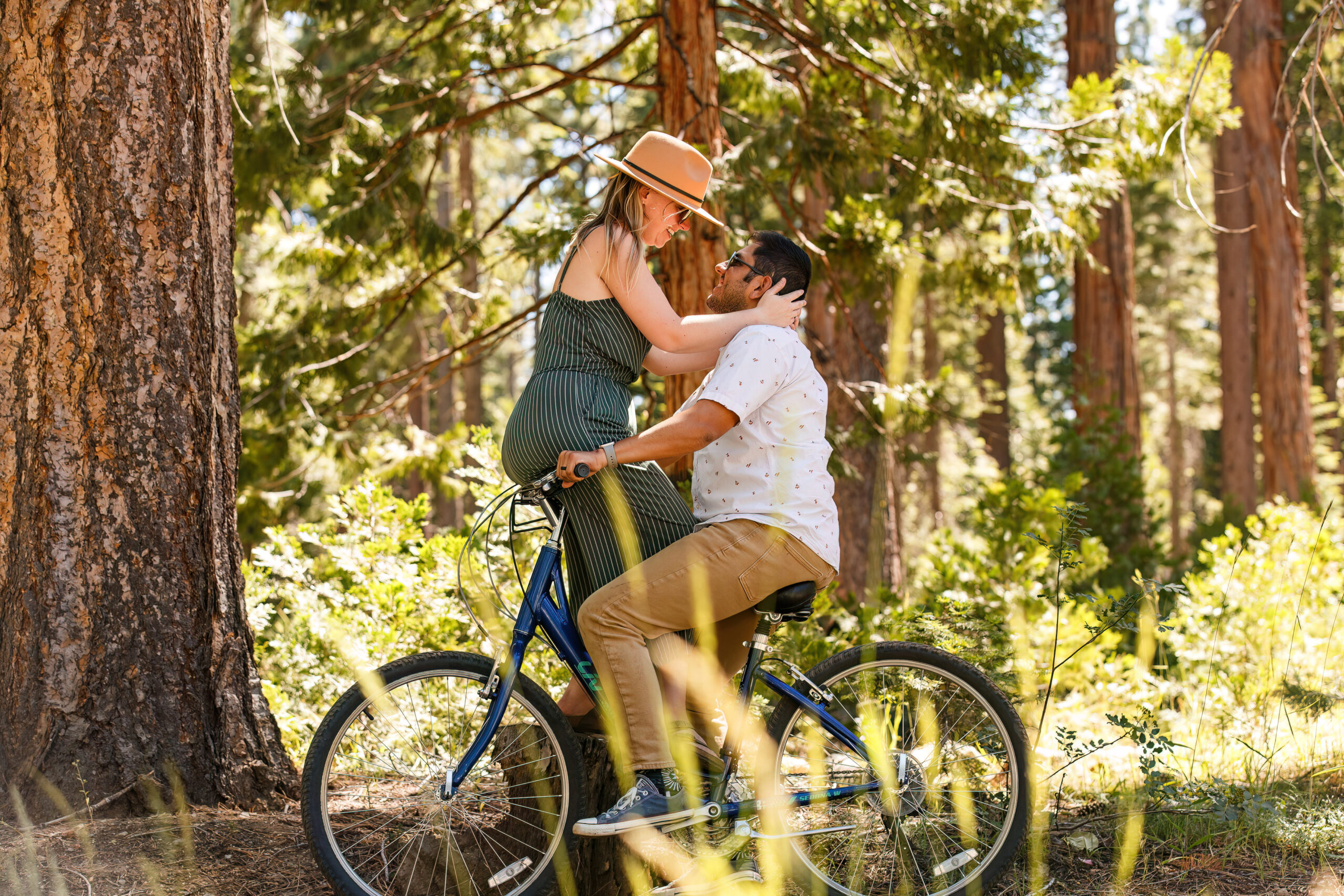 a woman sitting on handle bars as her fiance drives