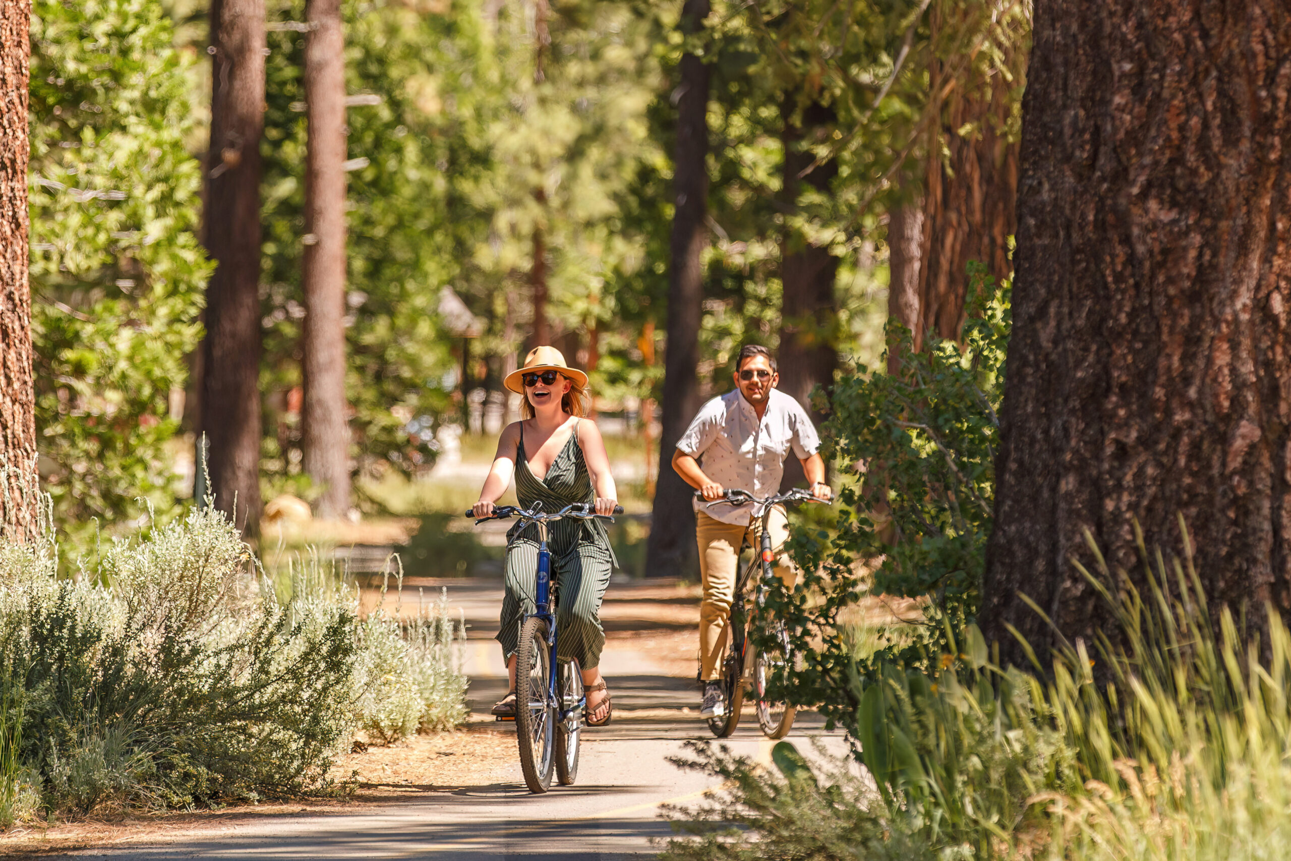 newly engaged couple riding their bikes through Lake Tahoe's trails for their engagement photos