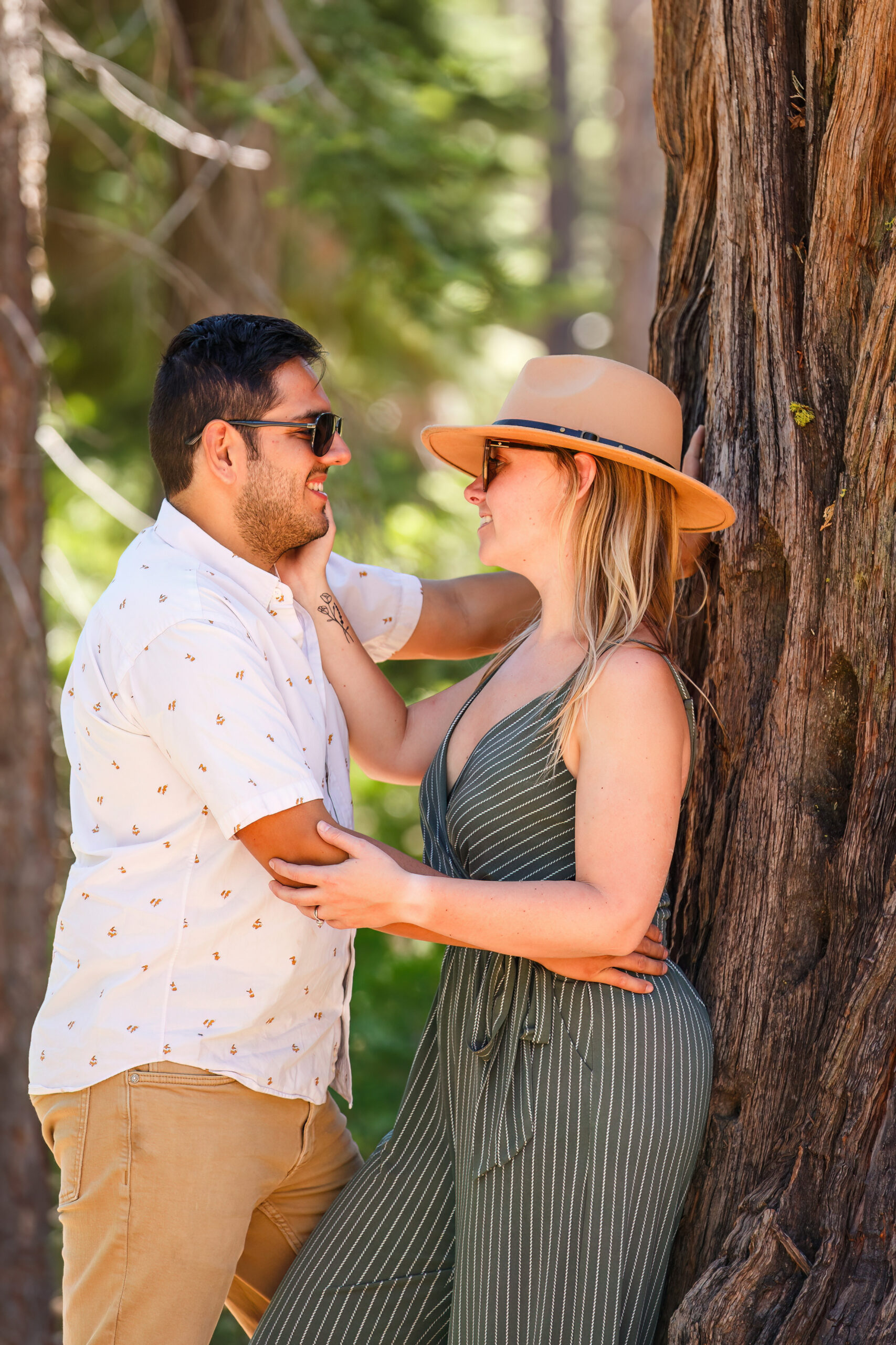 a couple leaning up against a tree together for Lake Tahoe engagement photos
