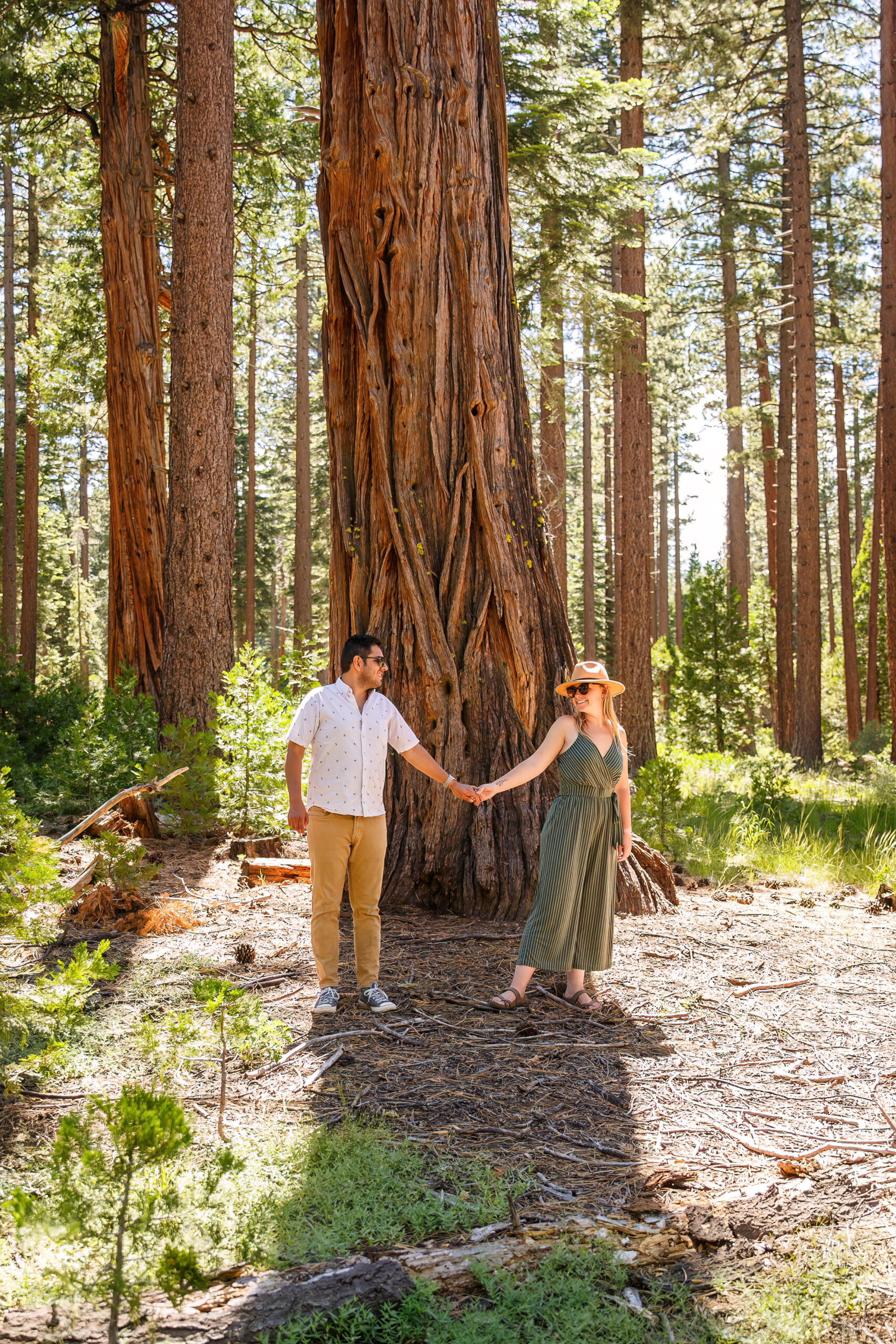 a couple holding hands and smiling at each other in Lake Tahoe