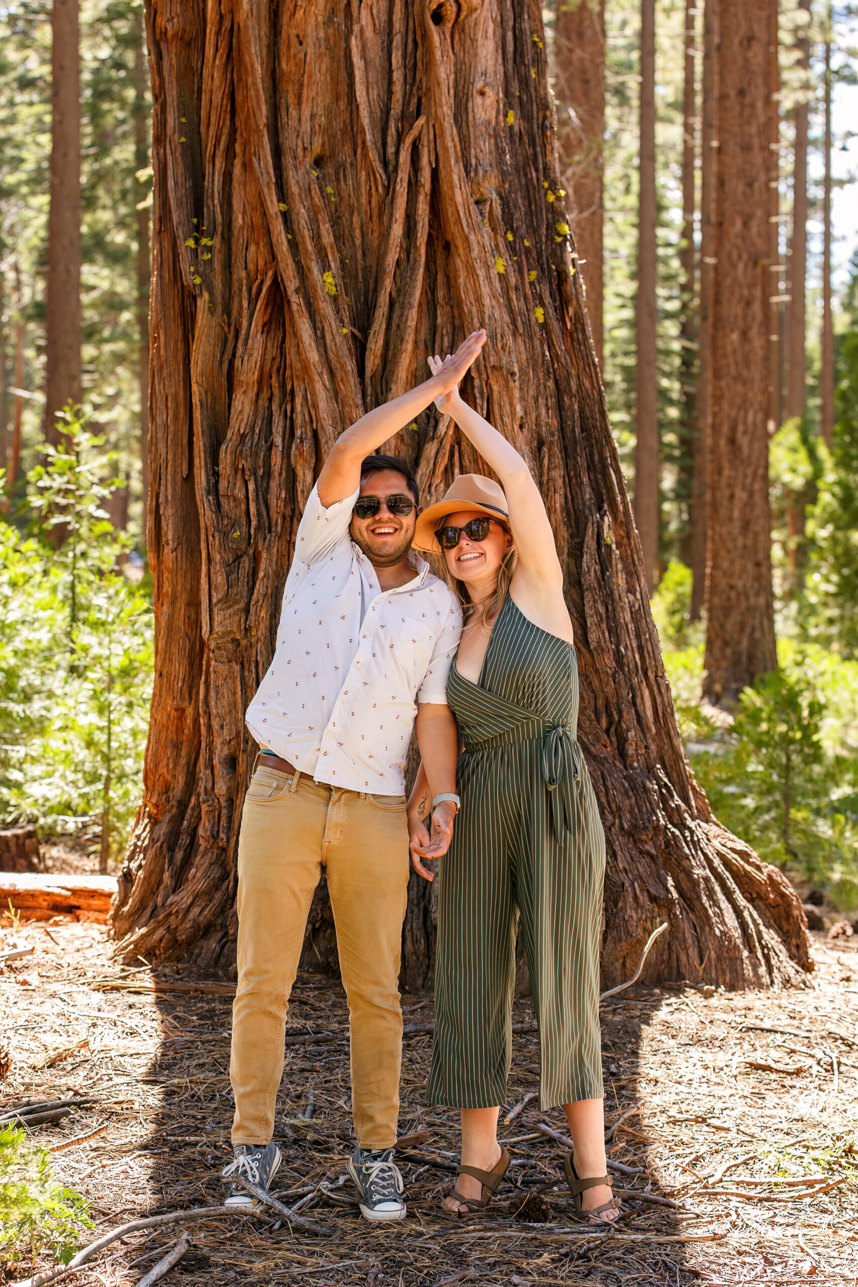 a couple clapping their hands together above their heads during their Lake Tahoe engagement photos