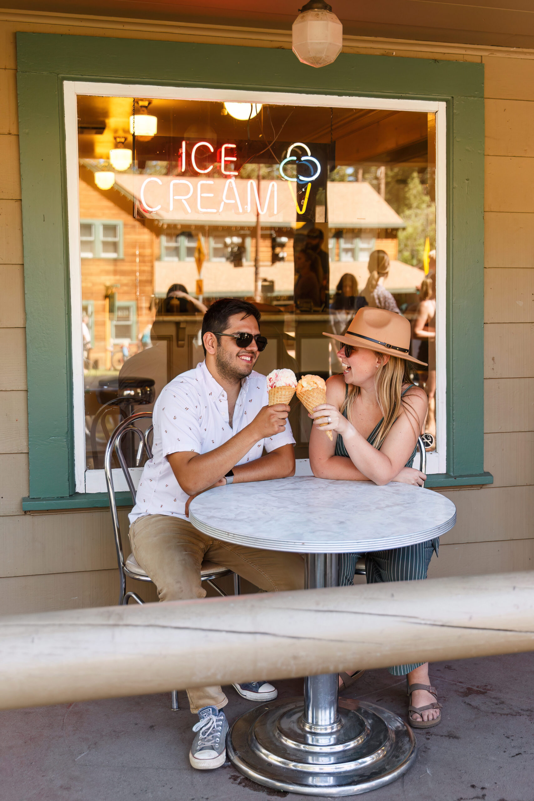 newly engaged couple eating ice cream and smiling during Lake Tahoe engagement photos