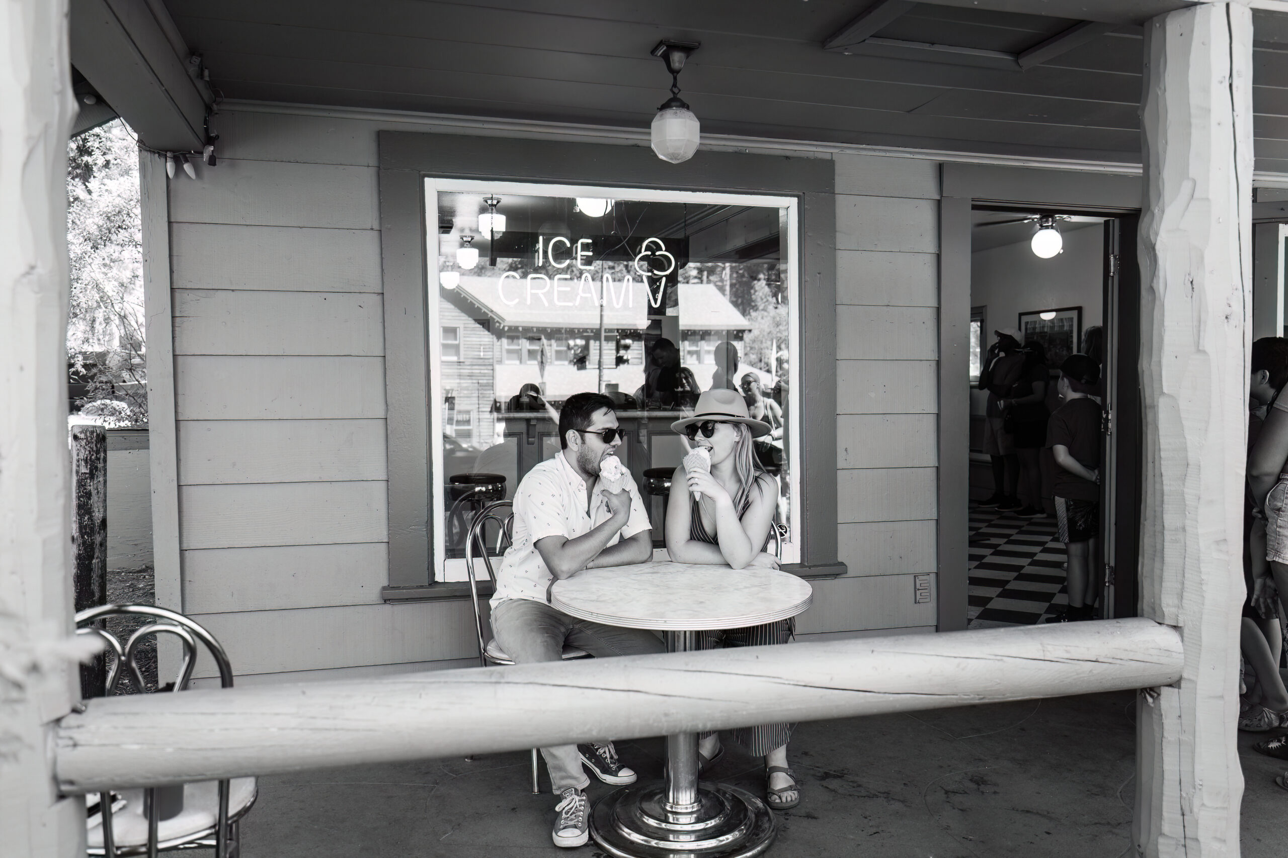 candid engagement photos of a couple eating ice cream at the parlor in Lake Tahoe