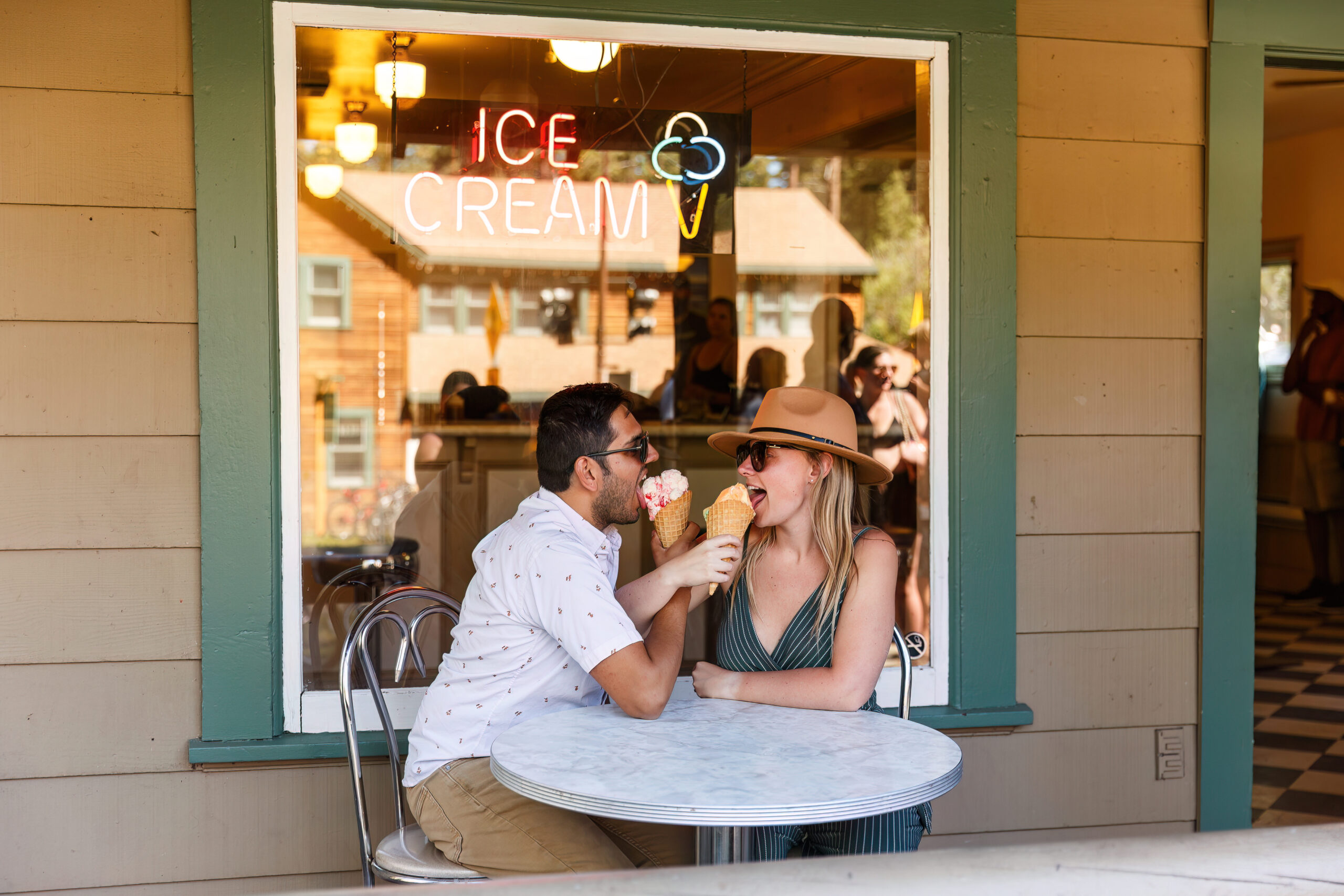 a couple looping their arms together as they eat their ice cream during Lake Tahoe engagement photos