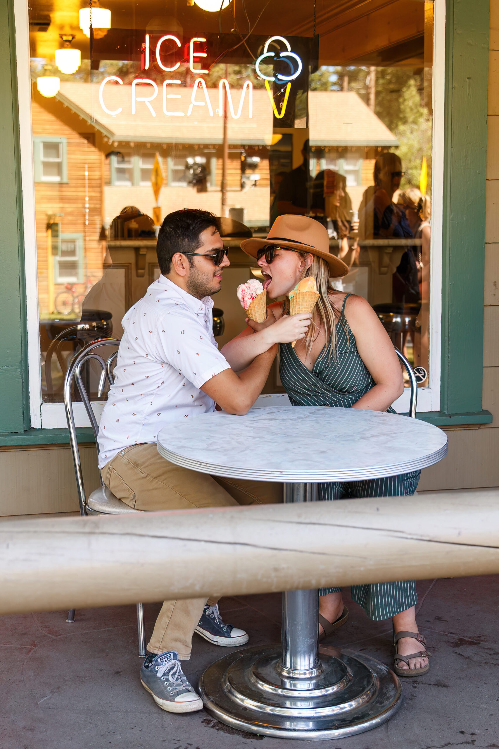 newly engaged couple trying each other's ice cream during their Lake Tahoe engagement photos