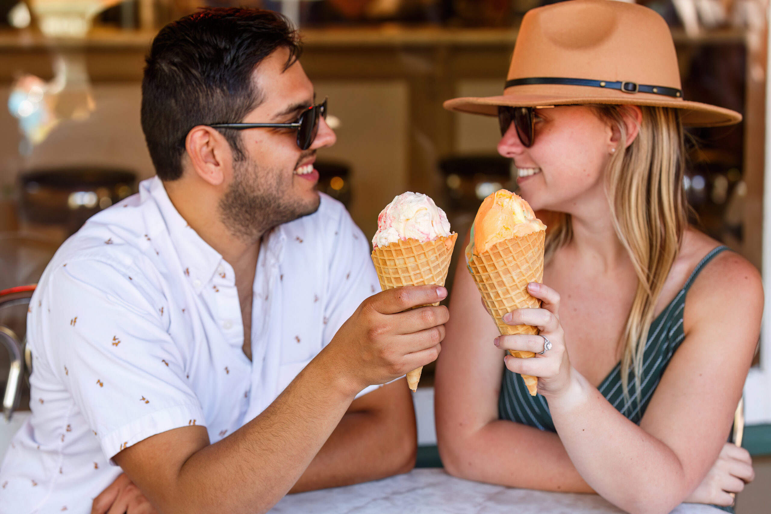 newly engaged couple 'toasting' their ice cream cones