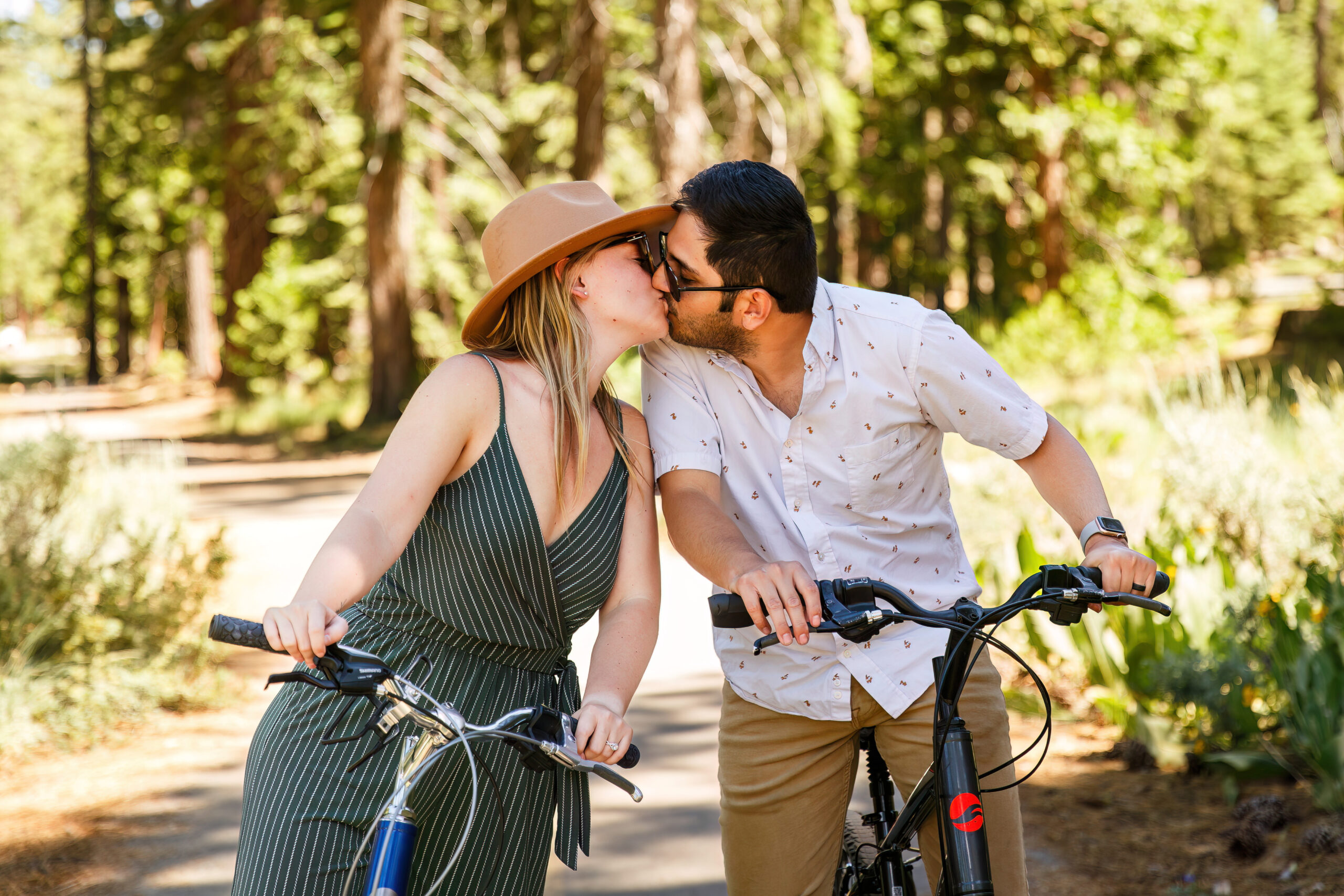 a couple stopping their bike ride for a quick kiss during their Lake Tahoe engagement photos