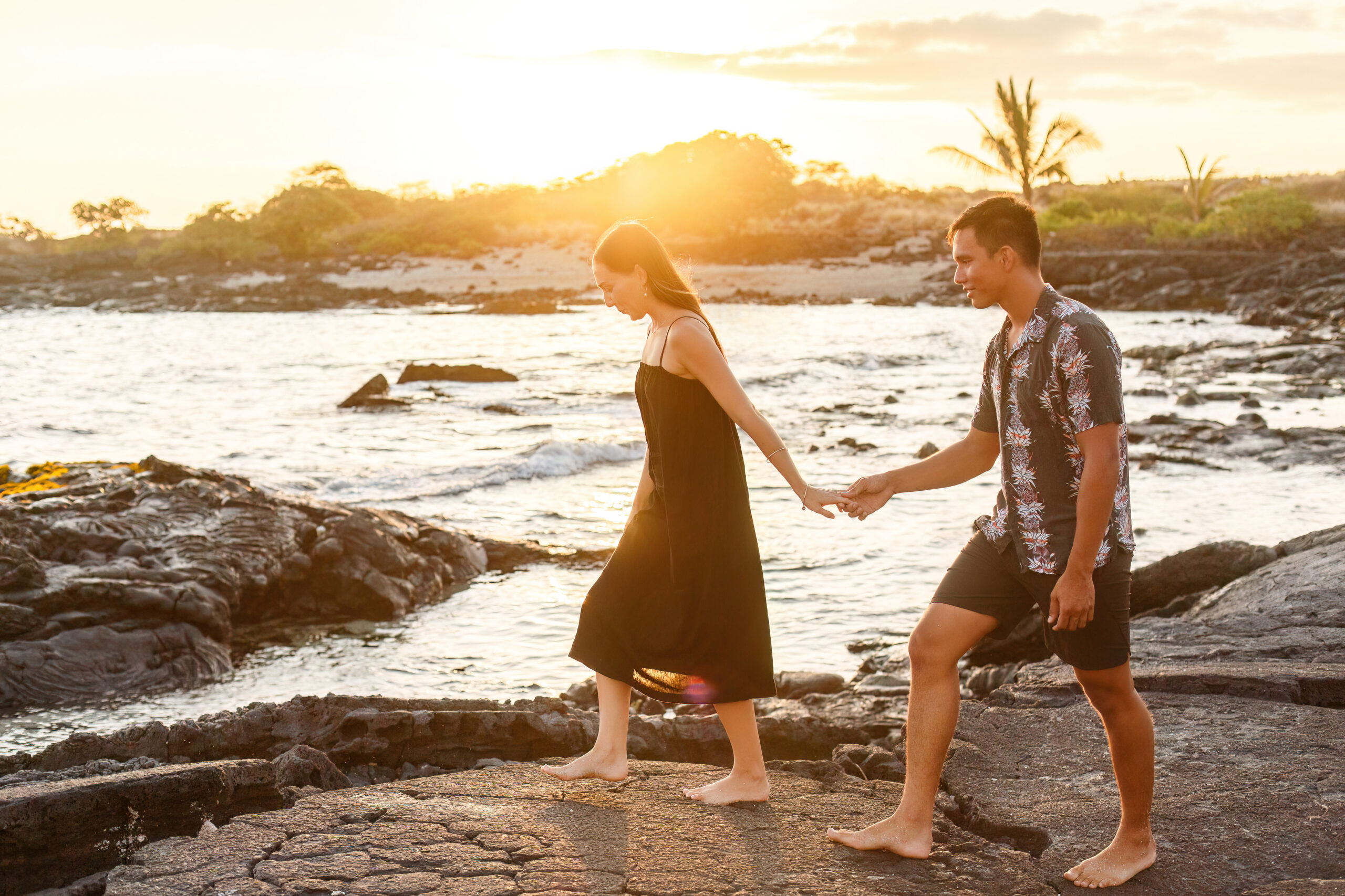 a couple holding hands walking on the beach