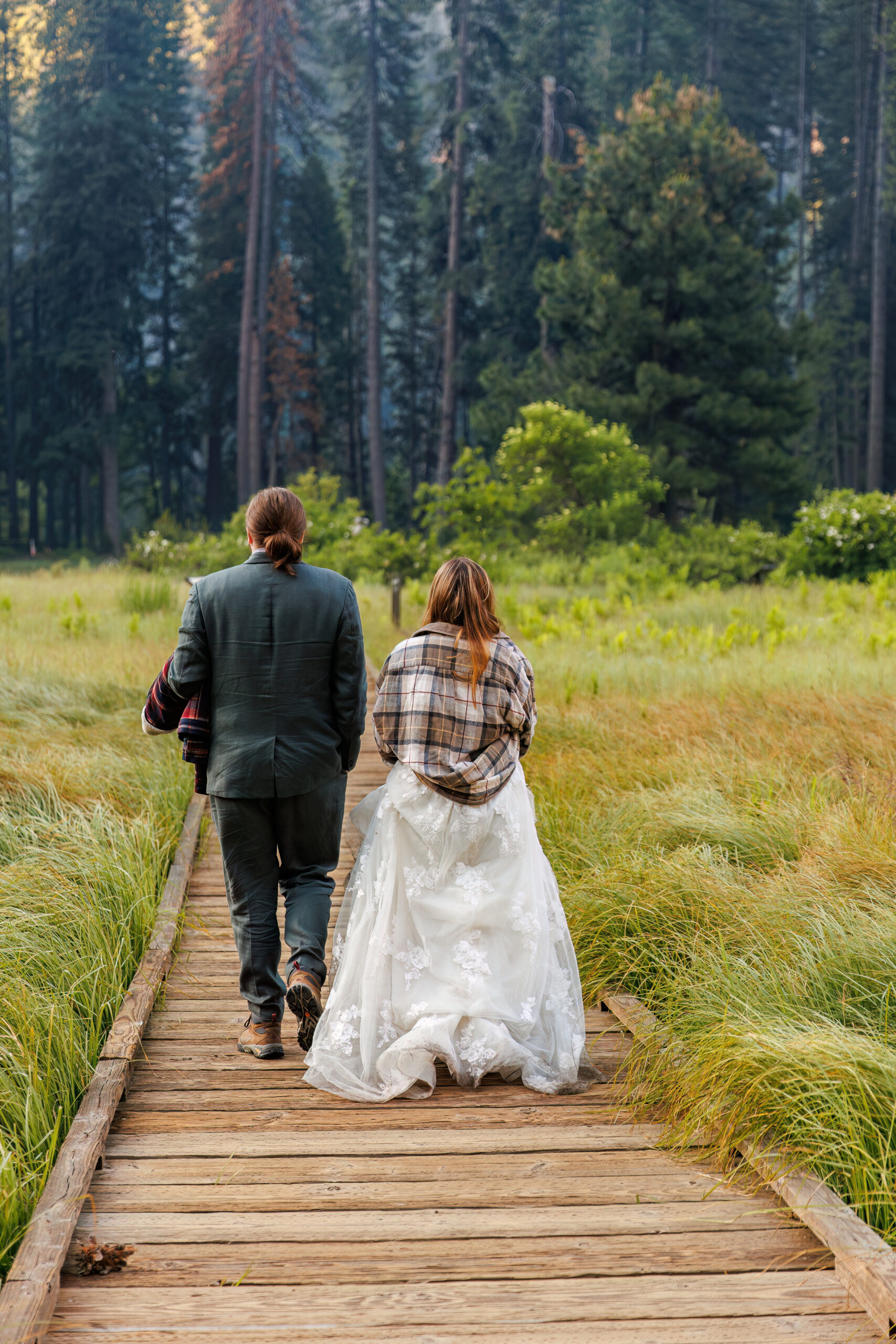 a couple walking down a path during their adventurous after session