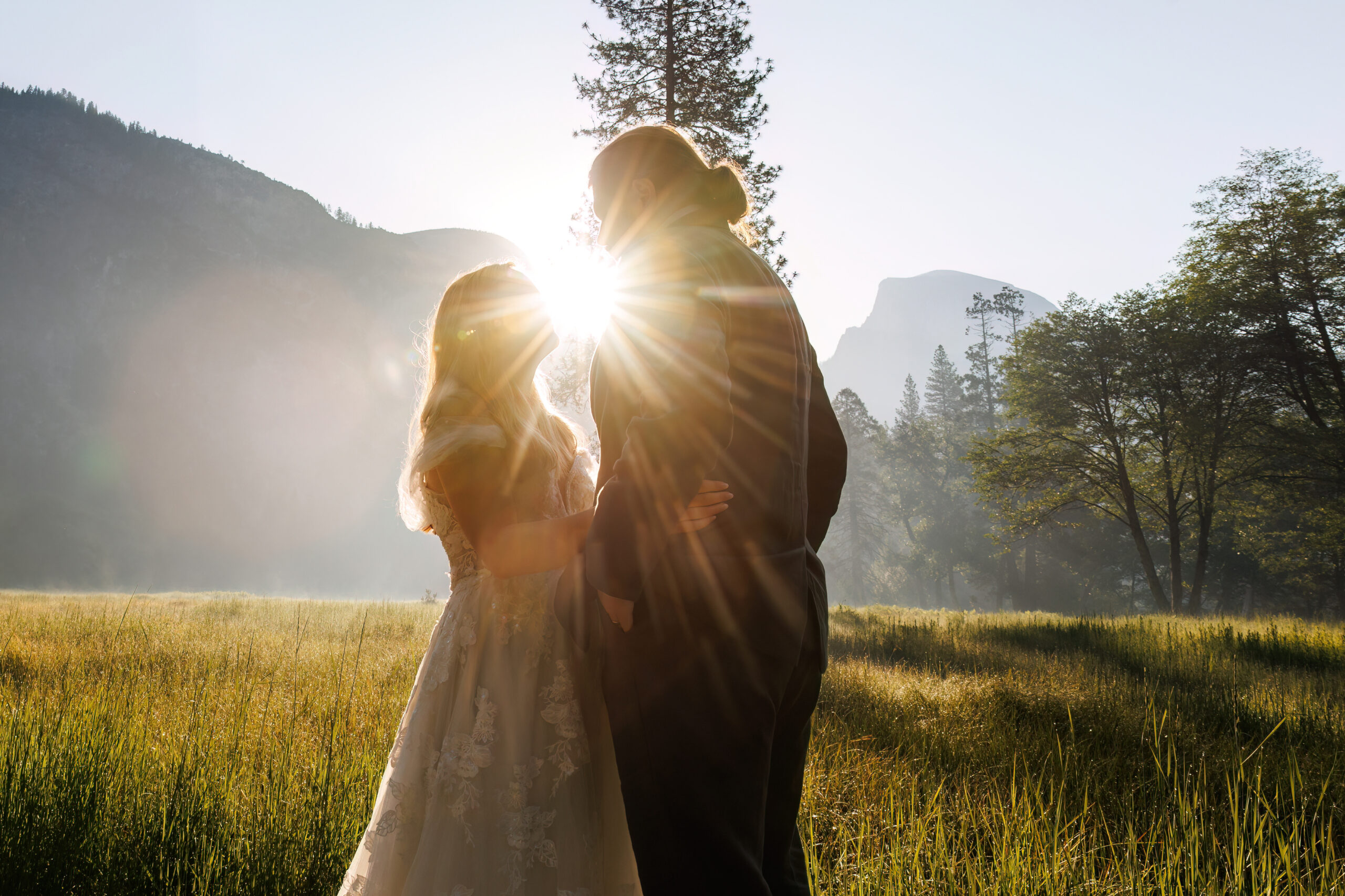 the sun shining between the couples' faces during their after session