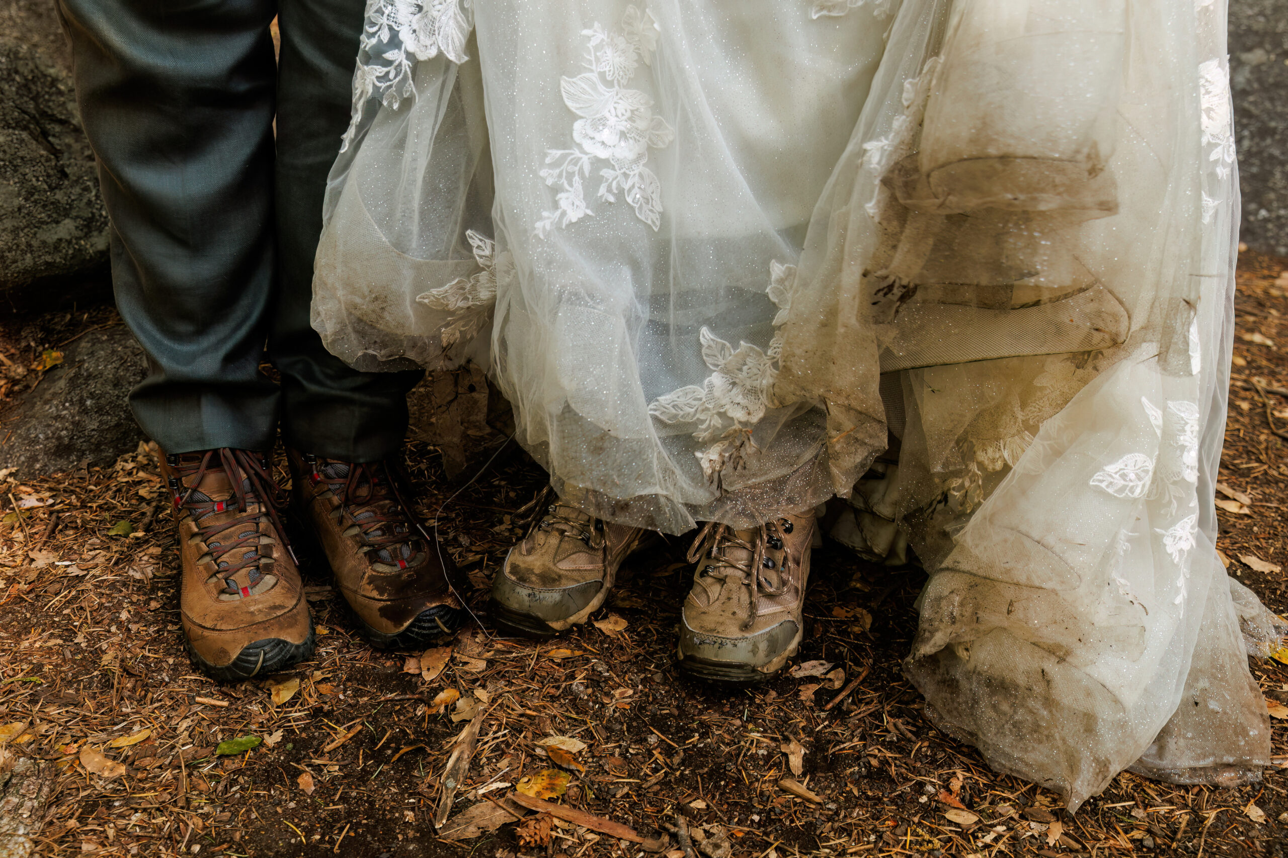 the couples' hiking boots and the bride's dirty dress from the adventure