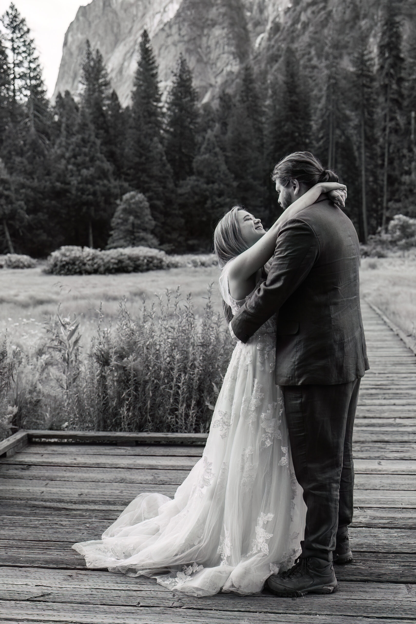 newly weds dancing on a bridge during their Yosemite wedding photos